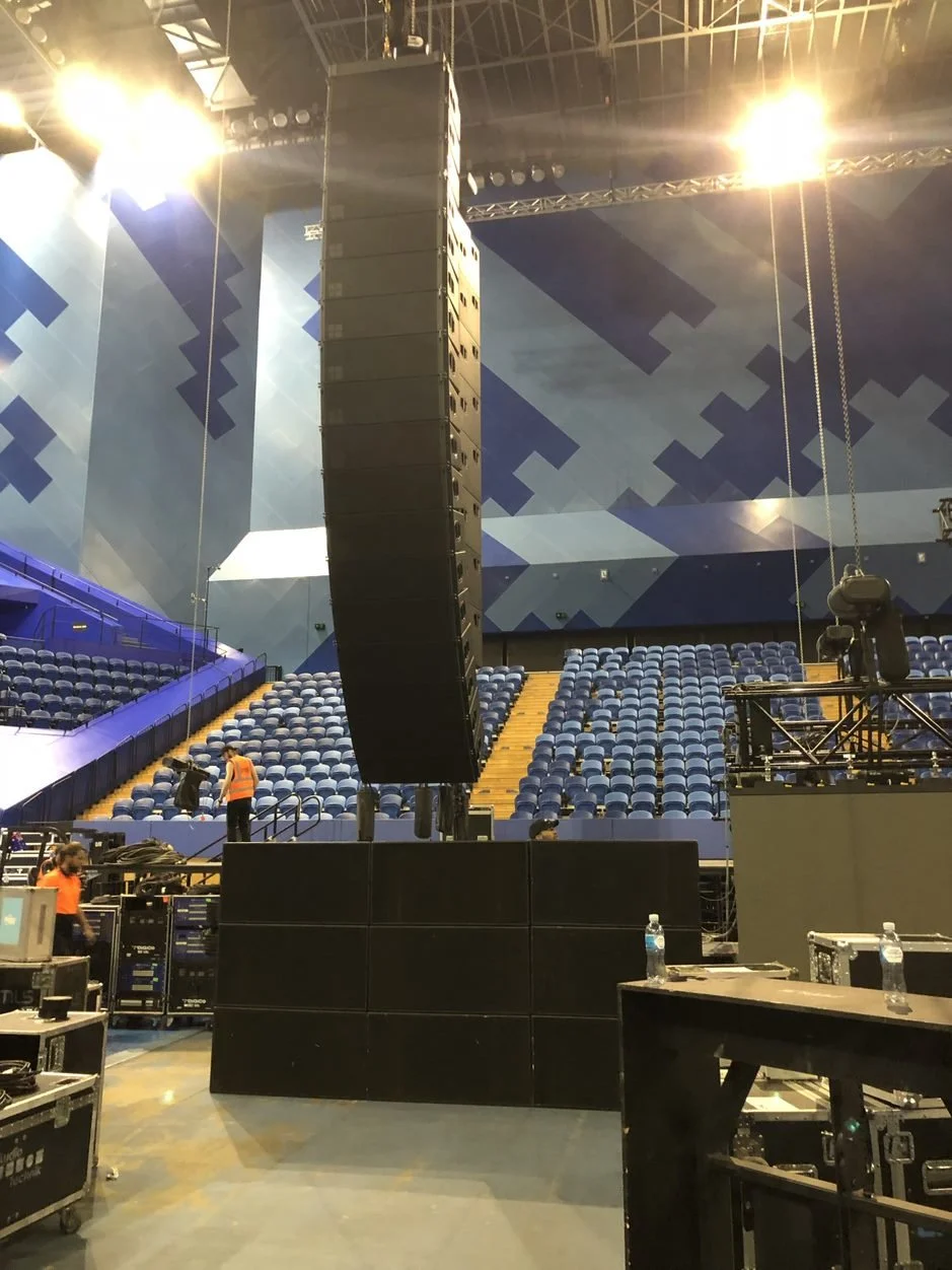 concert venue setup with speakers and seating