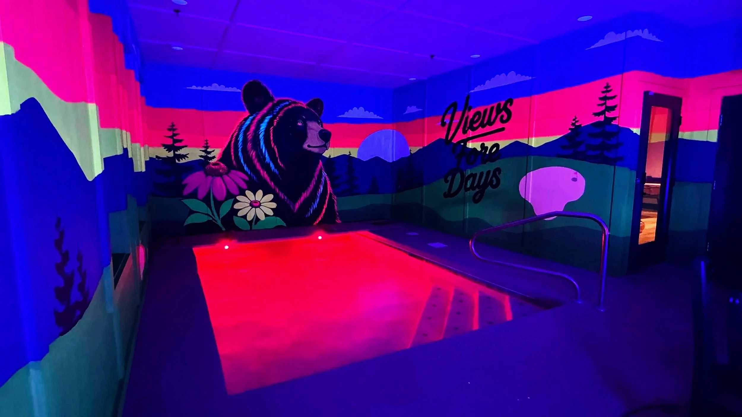 Smoky Mountain sunset cabin mural with a playful black bear at a Tennessee Airbnb by Sarah Meitler Murals