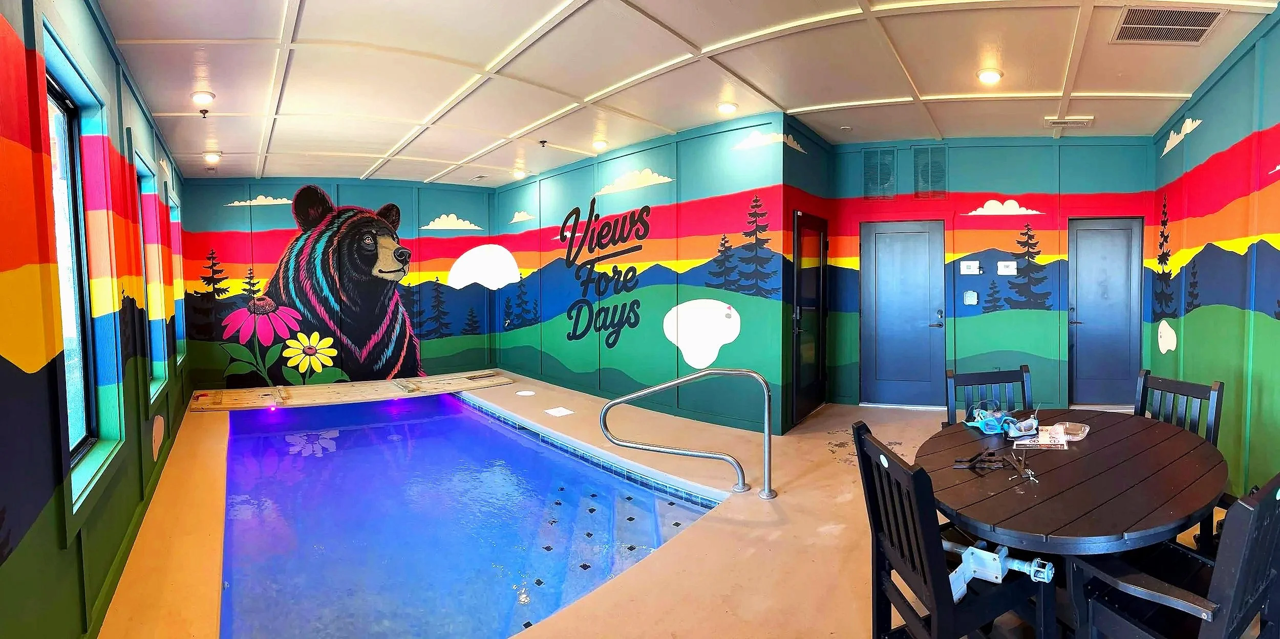 Smoky Mountain sunset cabin mural with a playful black bear at a Tennessee Airbnb by Sarah Meitler Murals