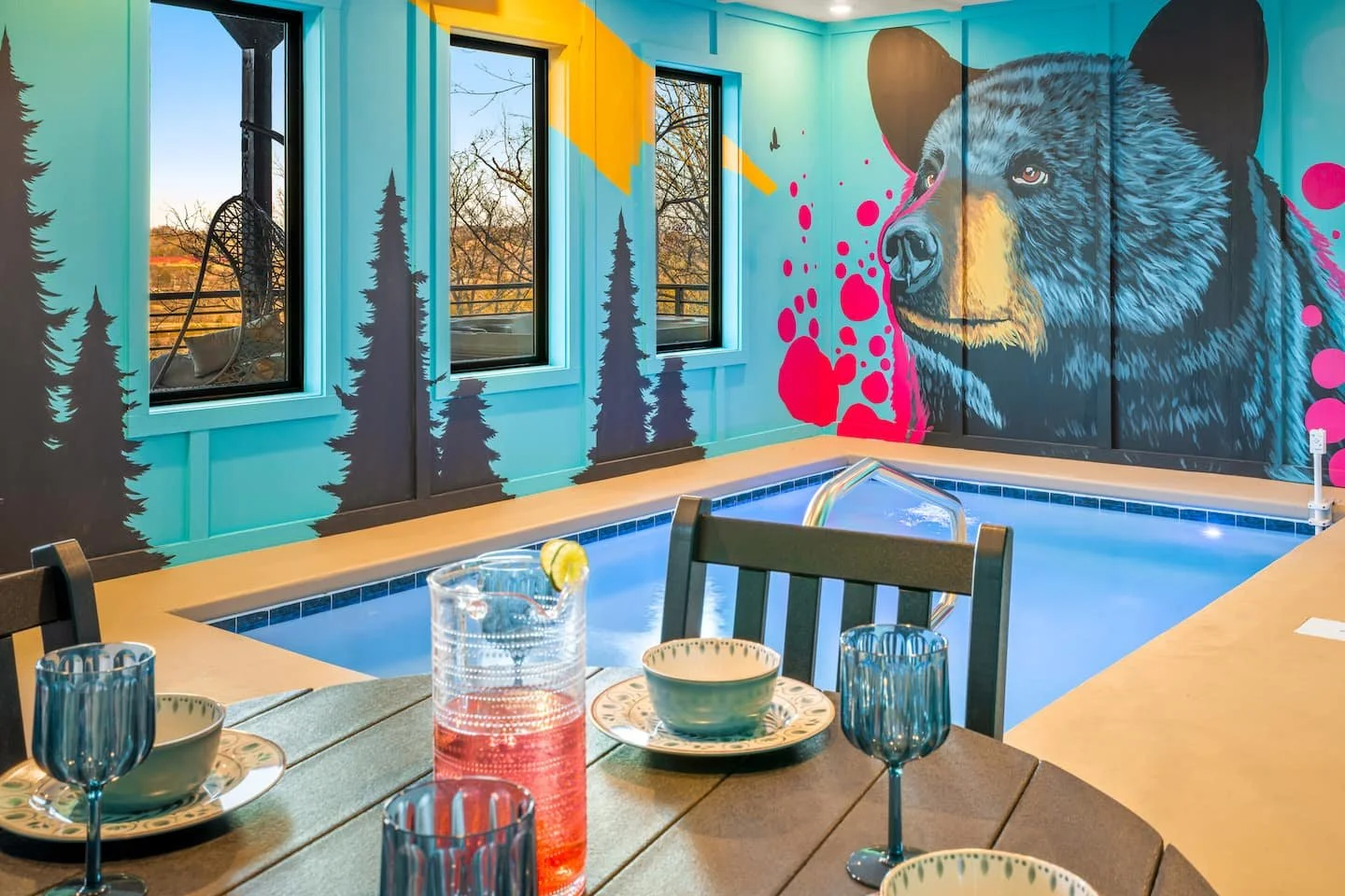 Vibrant pop-art black bear wall mural with forest silhouettes in a Smoky Mountains cabin.