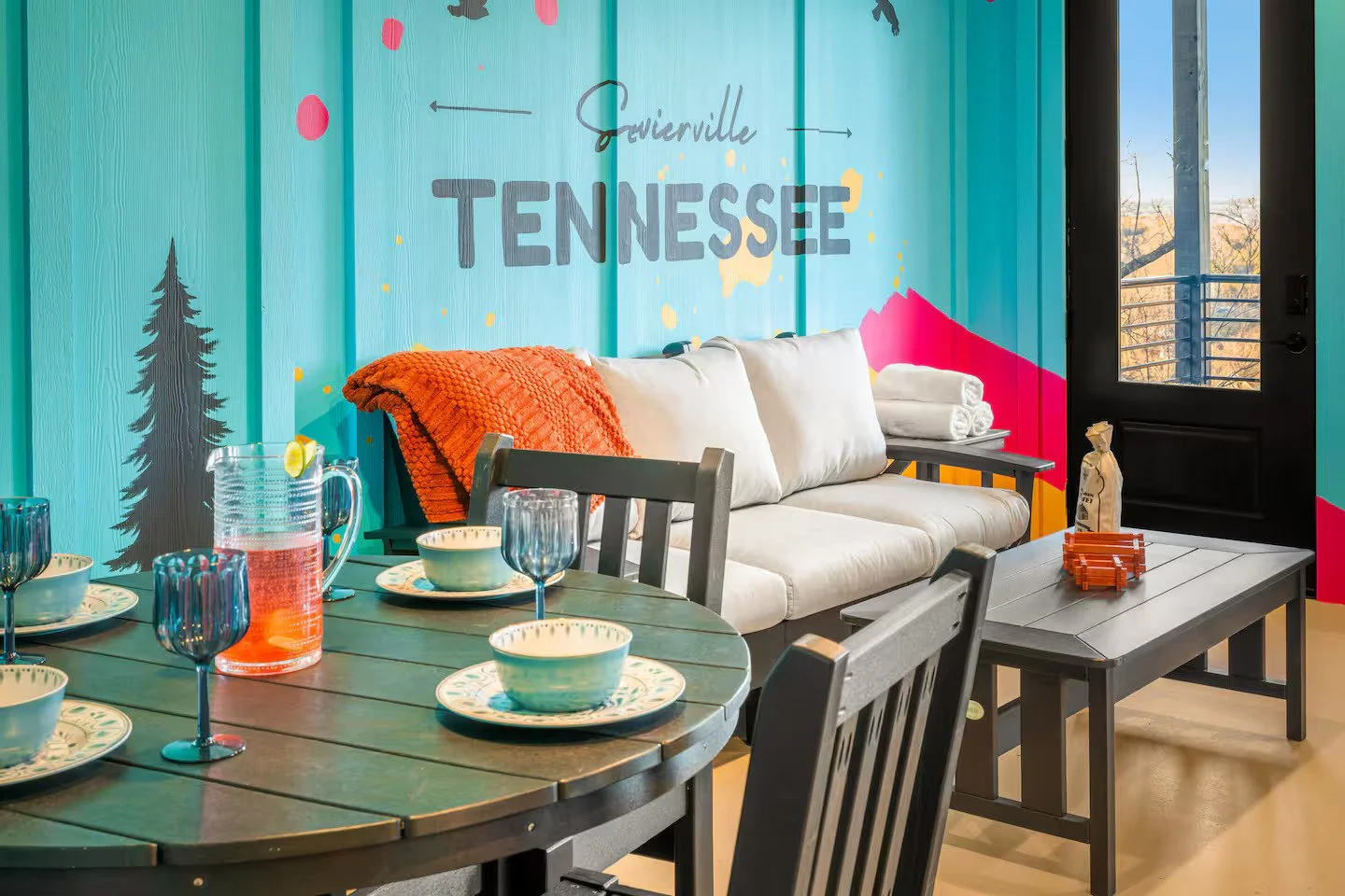 Vibrant pop-art black bear wall mural with forest silhouettes in a Smoky Mountains cabin.