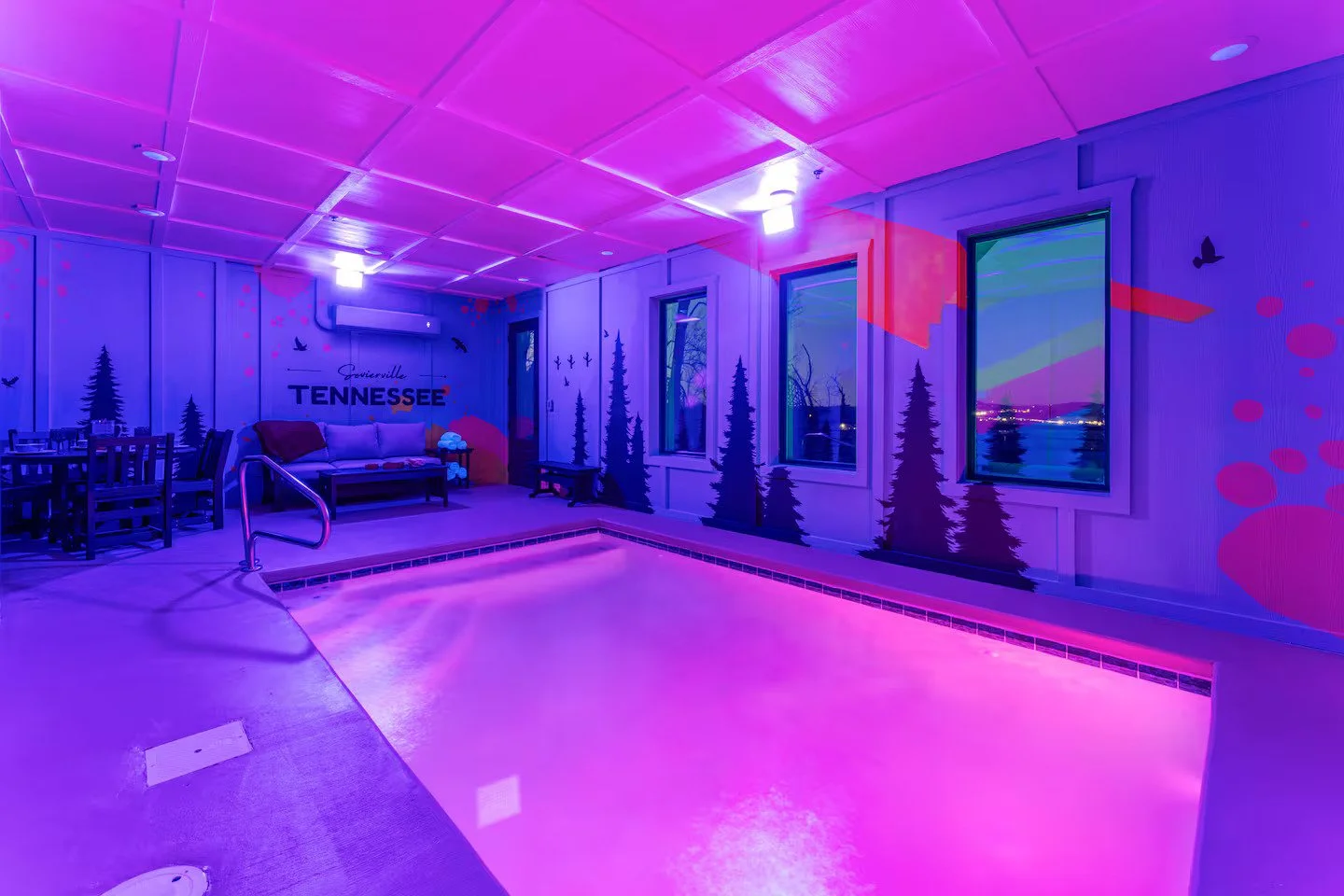 Vibrant pop-art black bear wall mural with forest silhouettes in a Smoky Mountains cabin.