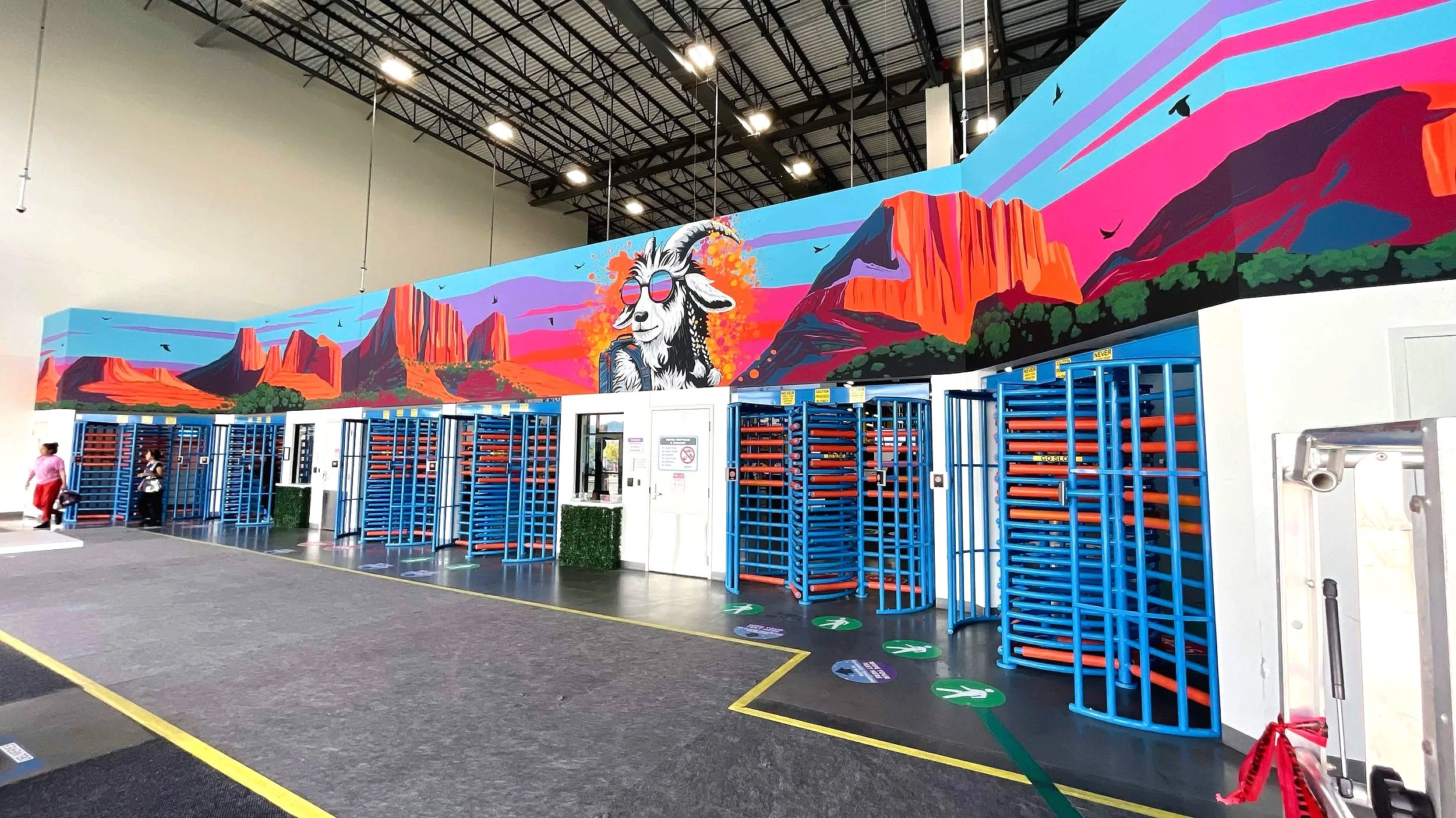 Custom mural of goat hiking with backpack at Amazon warehouse front entrance Zion Southern Utah