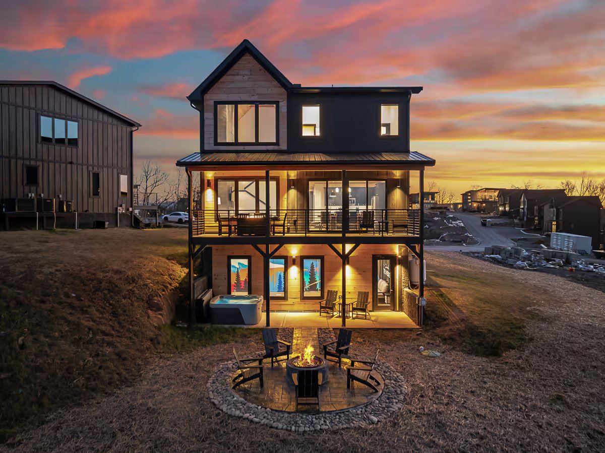 Vibrant neon-style mural of glowing mountains and pine forests in a Smoky Mountains cabin pool area.