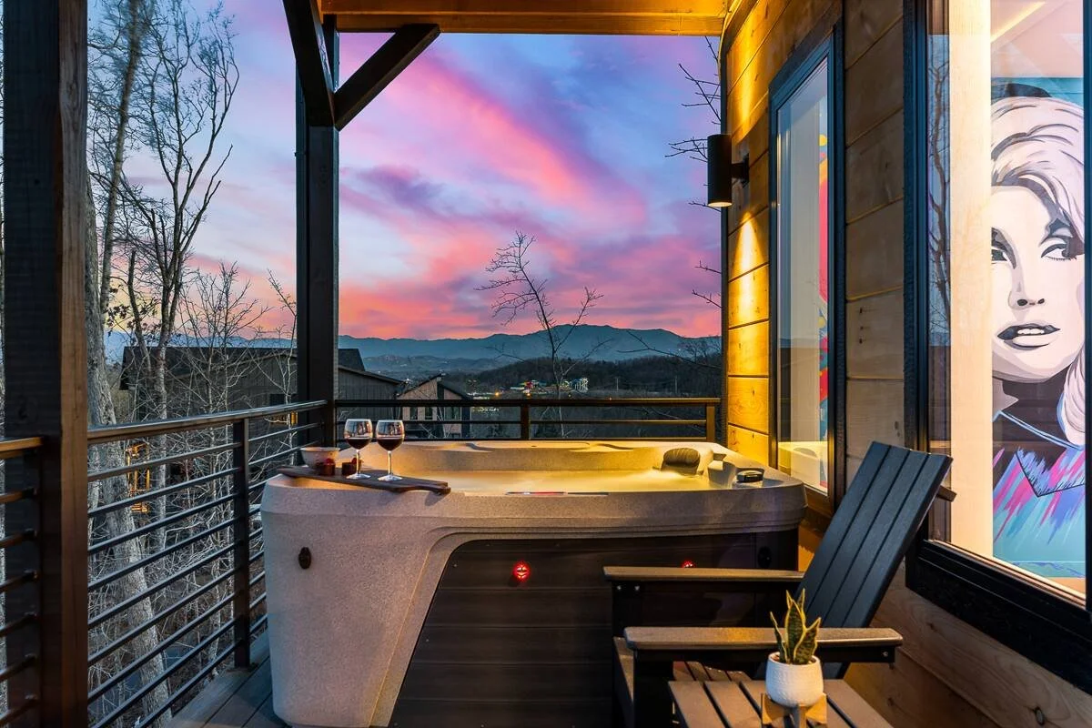 Vibrant neon-style Dolly Parton portrait mural with colorful butterflies in a Sevierville, Tennessee cabin.