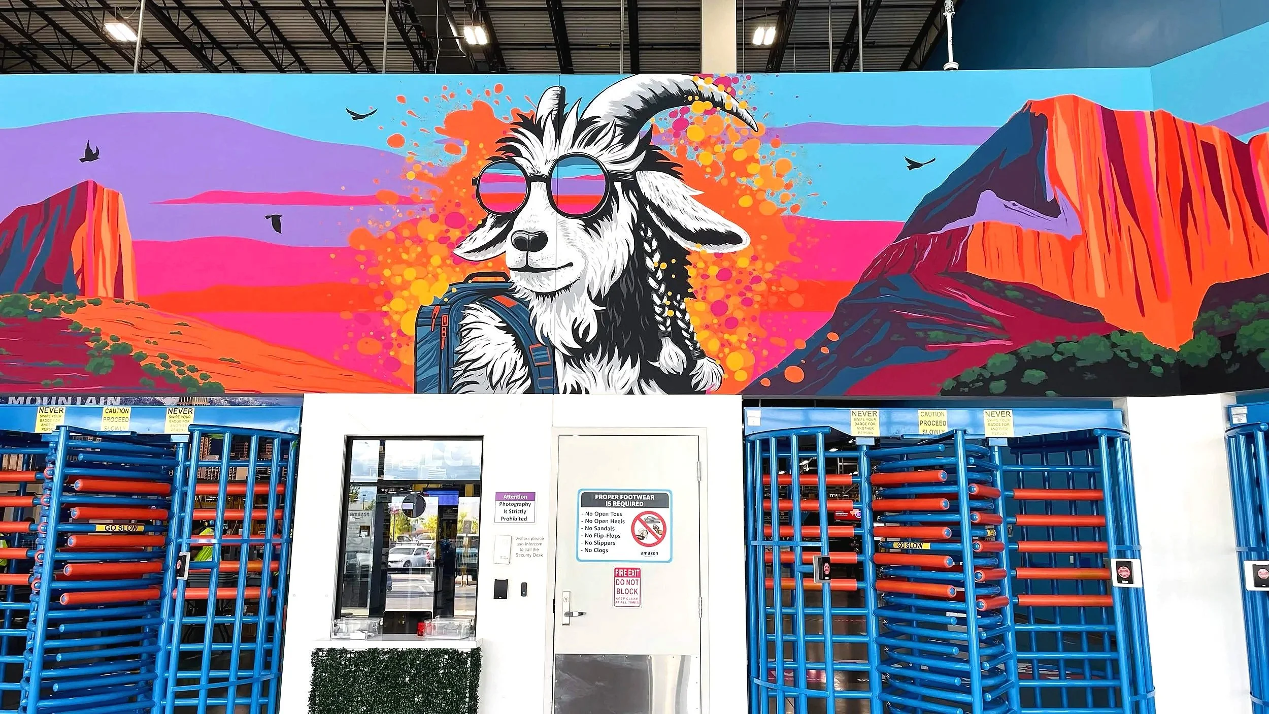Custom mural of goat hiking with backpack at Amazon warehouse front entrance Zion Southern Utah