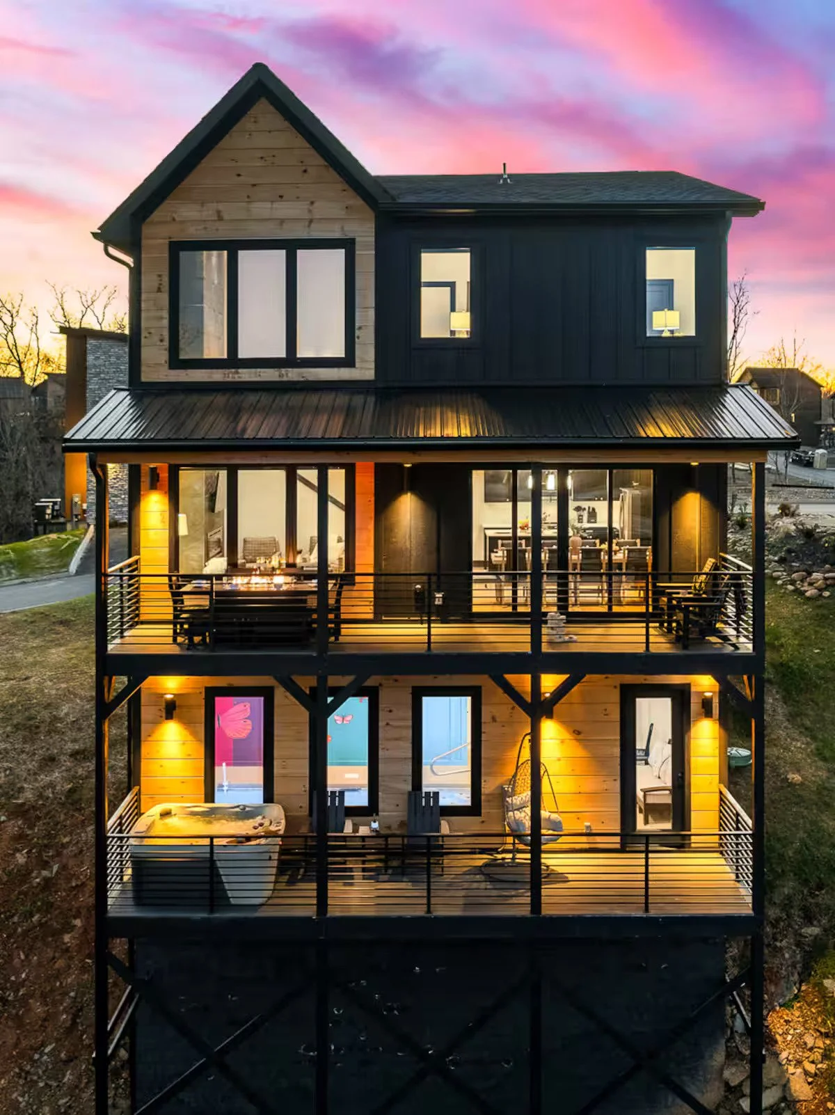 Vibrant neon-style Dolly Parton portrait mural with colorful butterflies in a Sevierville, Tennessee cabin.