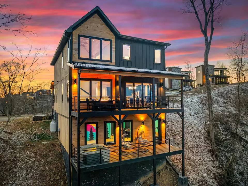 Vibrant pop-art black bear wall mural with forest silhouettes in a Smoky Mountains cabin.