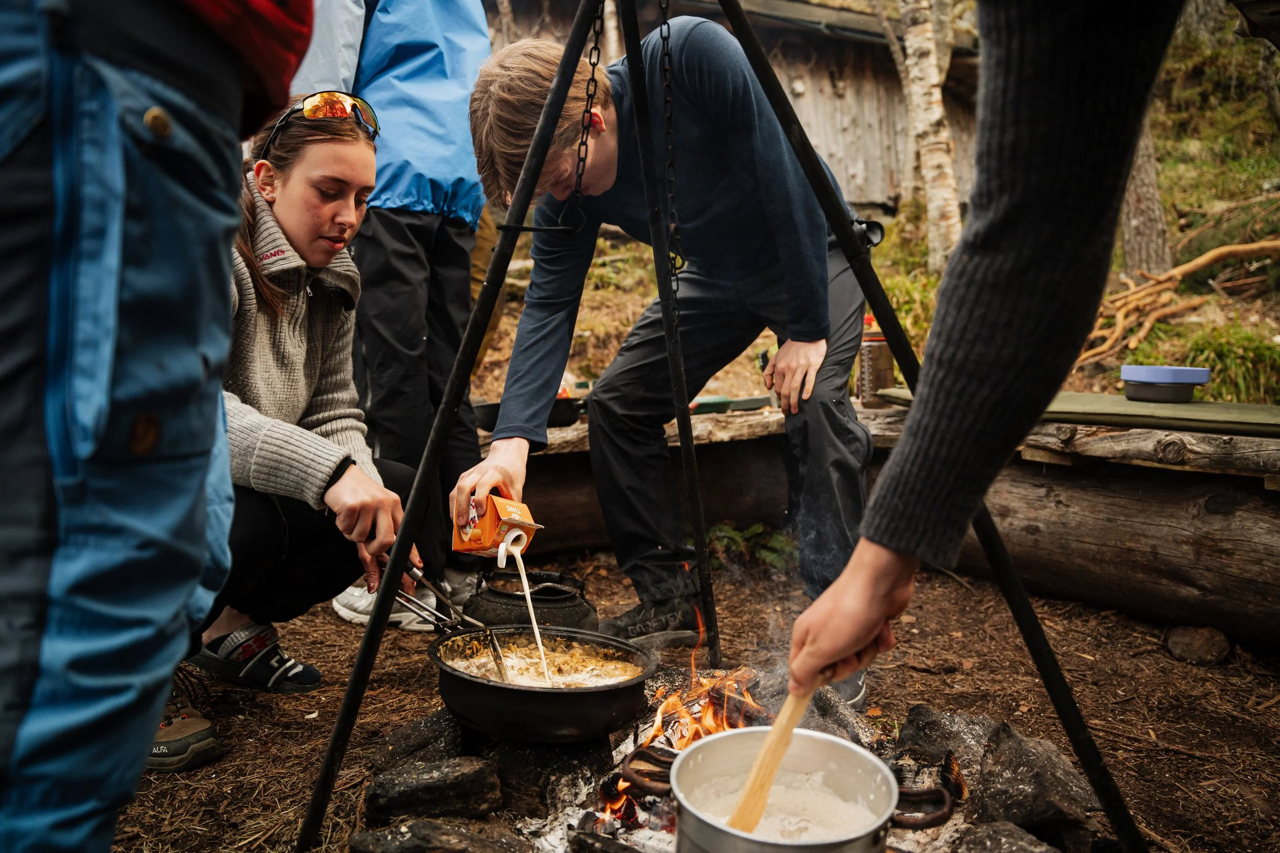 Students cooking on a campfire