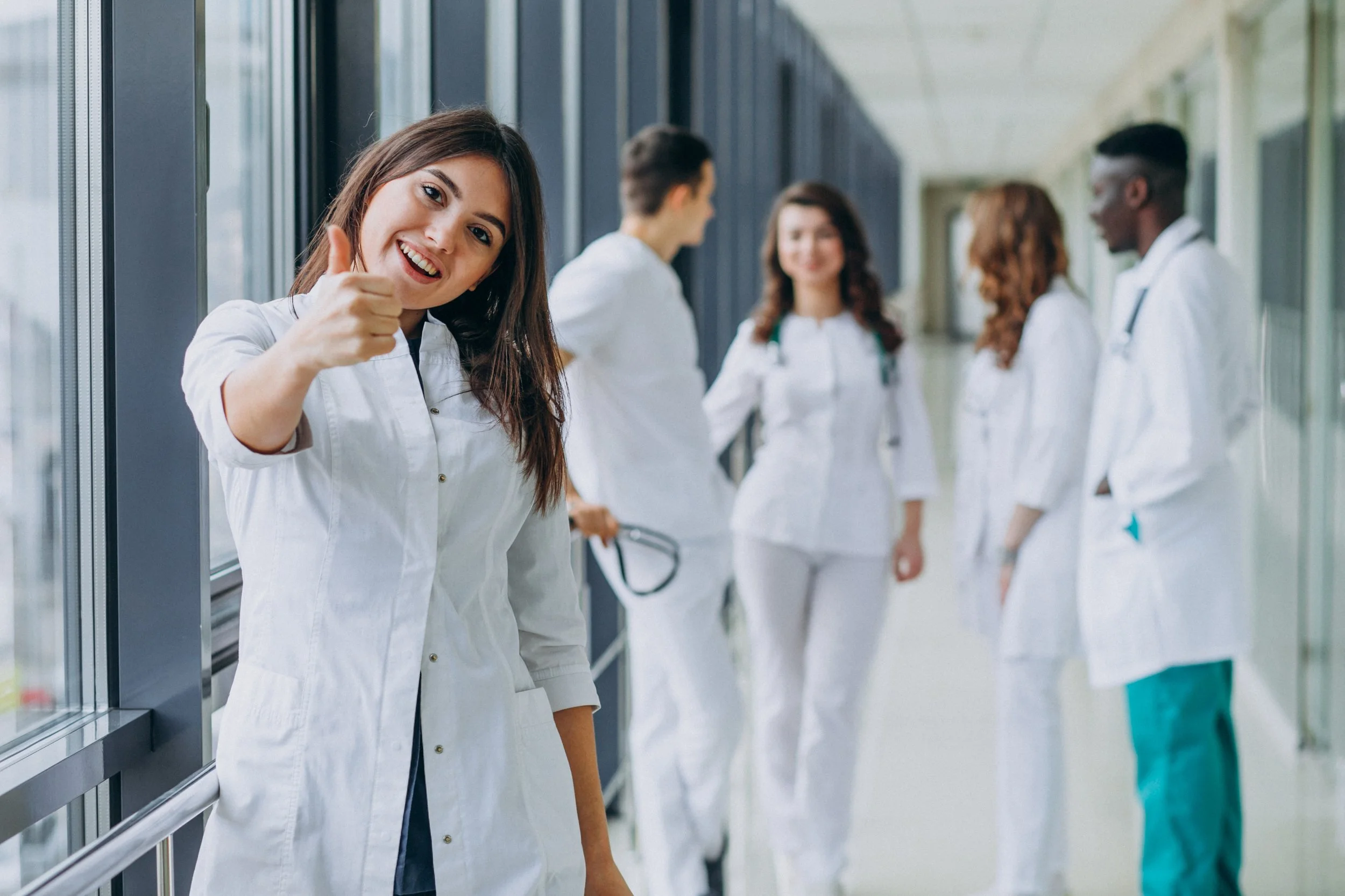 female doctor thumbs up