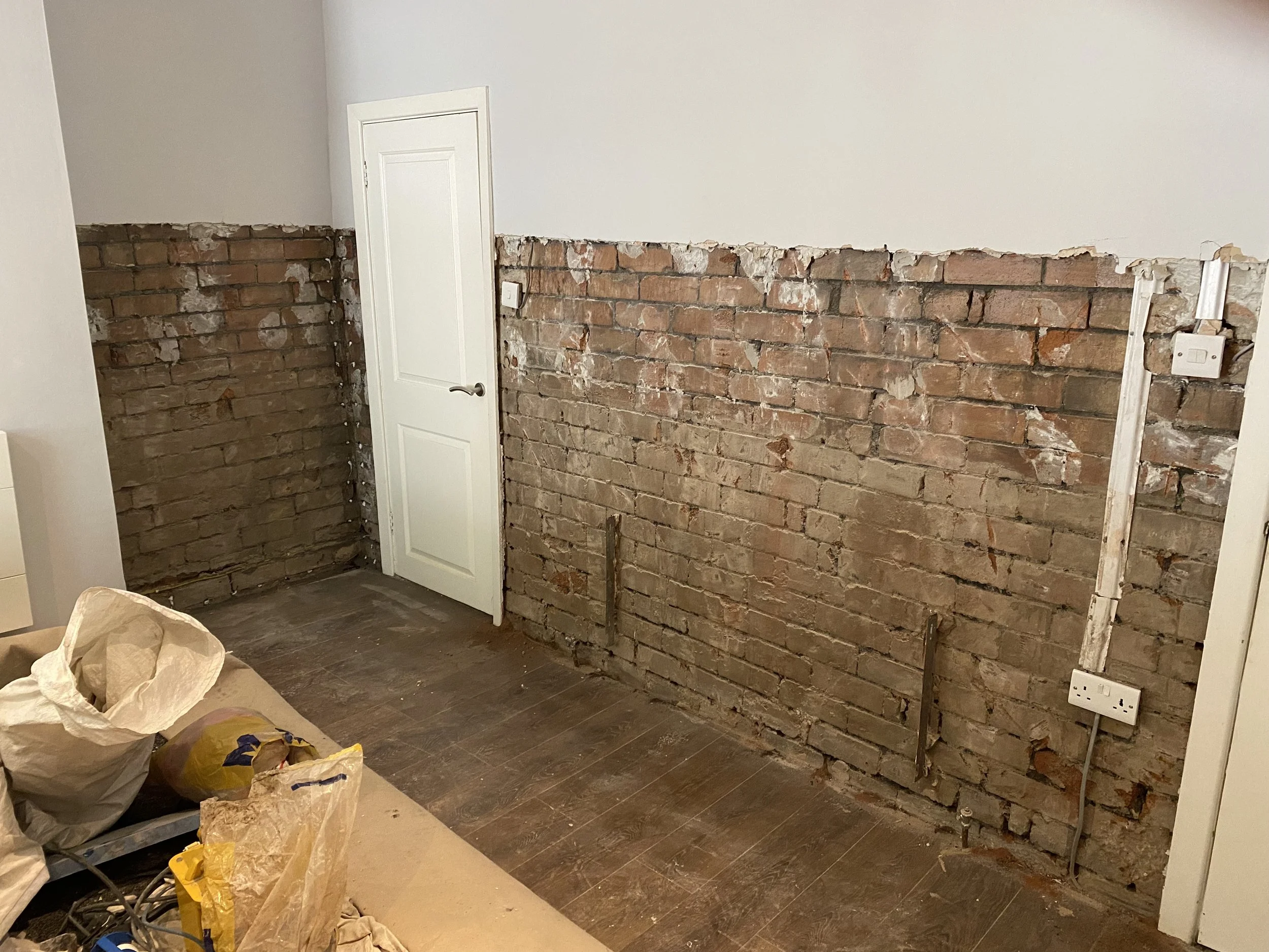 PLASTER KNOCKED OFF THE WALLS TO PREP FOR THE DAMP COURSE