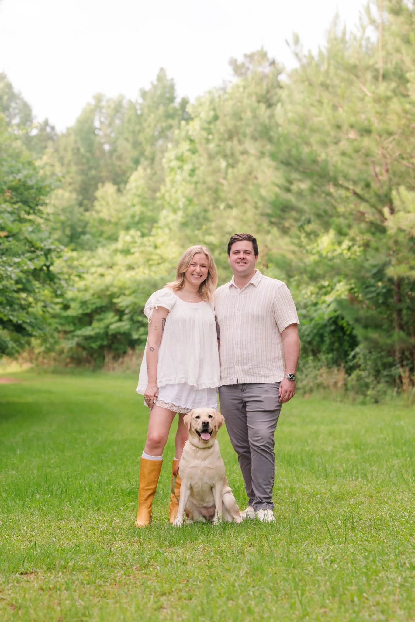 Woman and man, a couple, with yellow Labrador Retriever at Indian Creek Park Rutledge Georgia