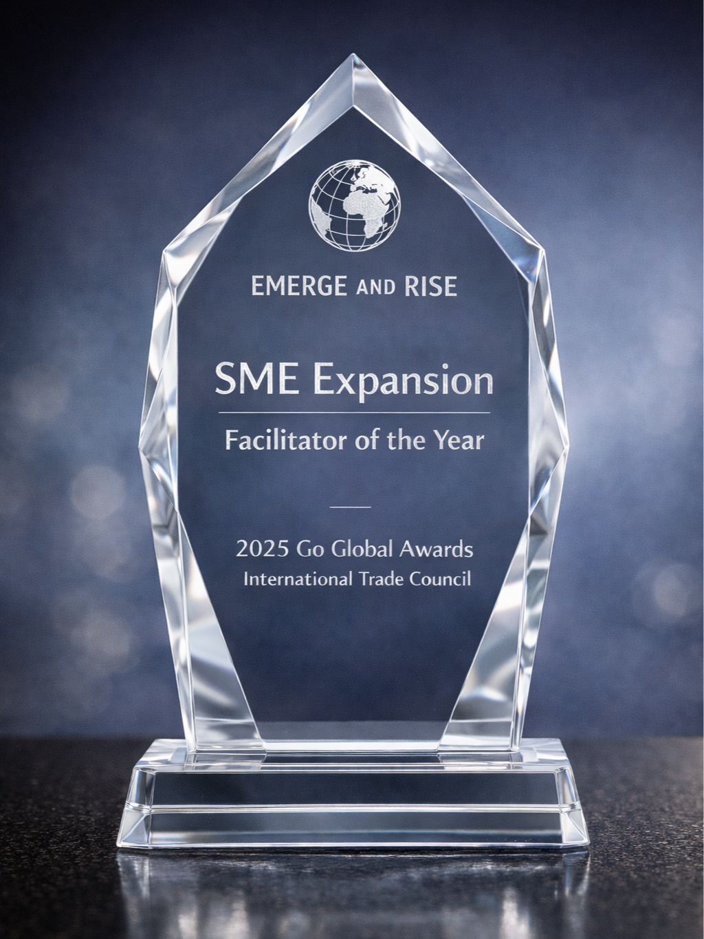 A clear glass award with a globe design at the top, inscribed with "Emerge and Rise," "SME Expansion," "Facilitator of the Year," and "2025 Go Global Awards, International Trade Council".