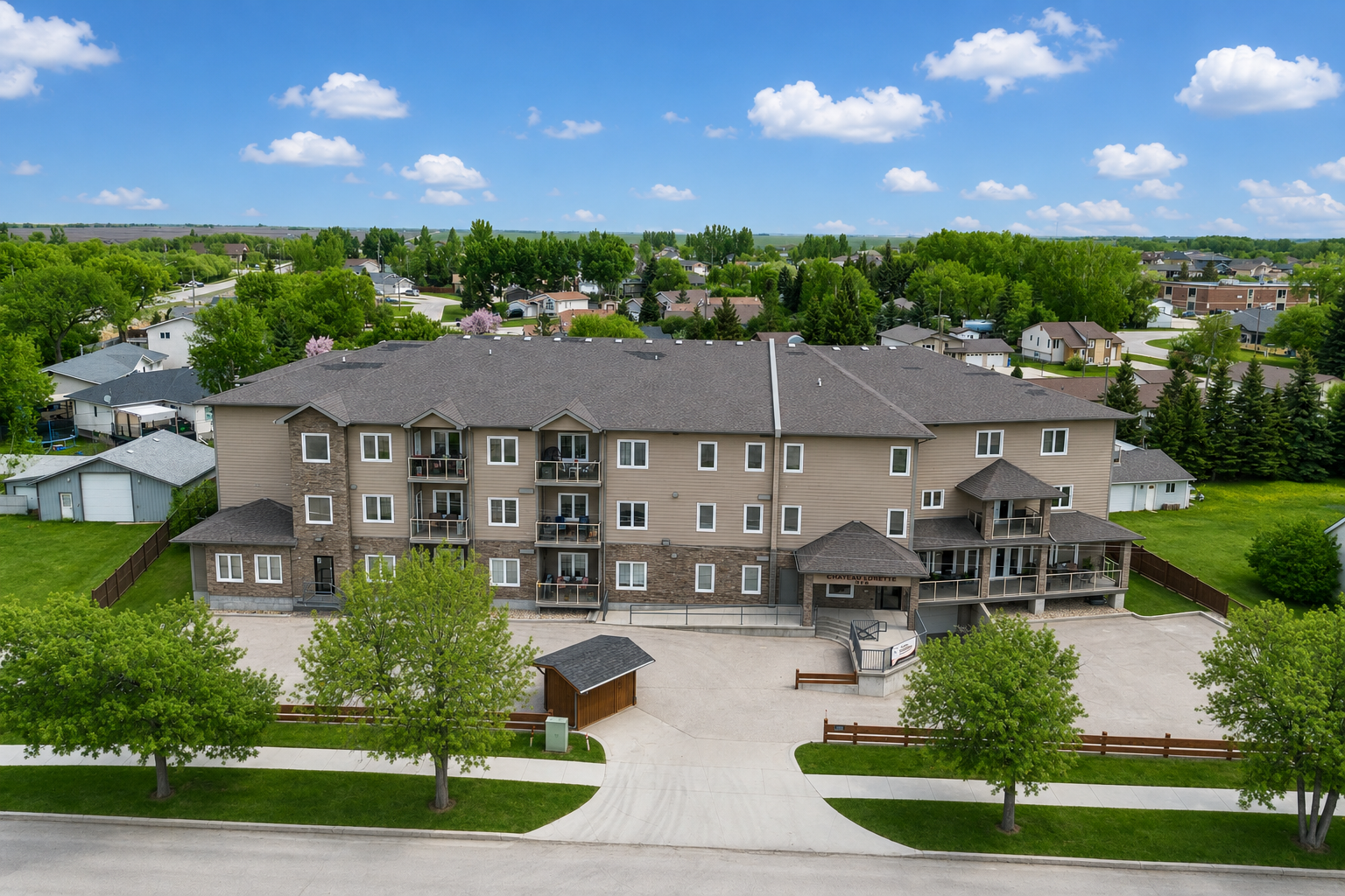 001 Exterior view of Chateau Lorette condos at 1223 Dawson Road in Lorette Manitoba.png