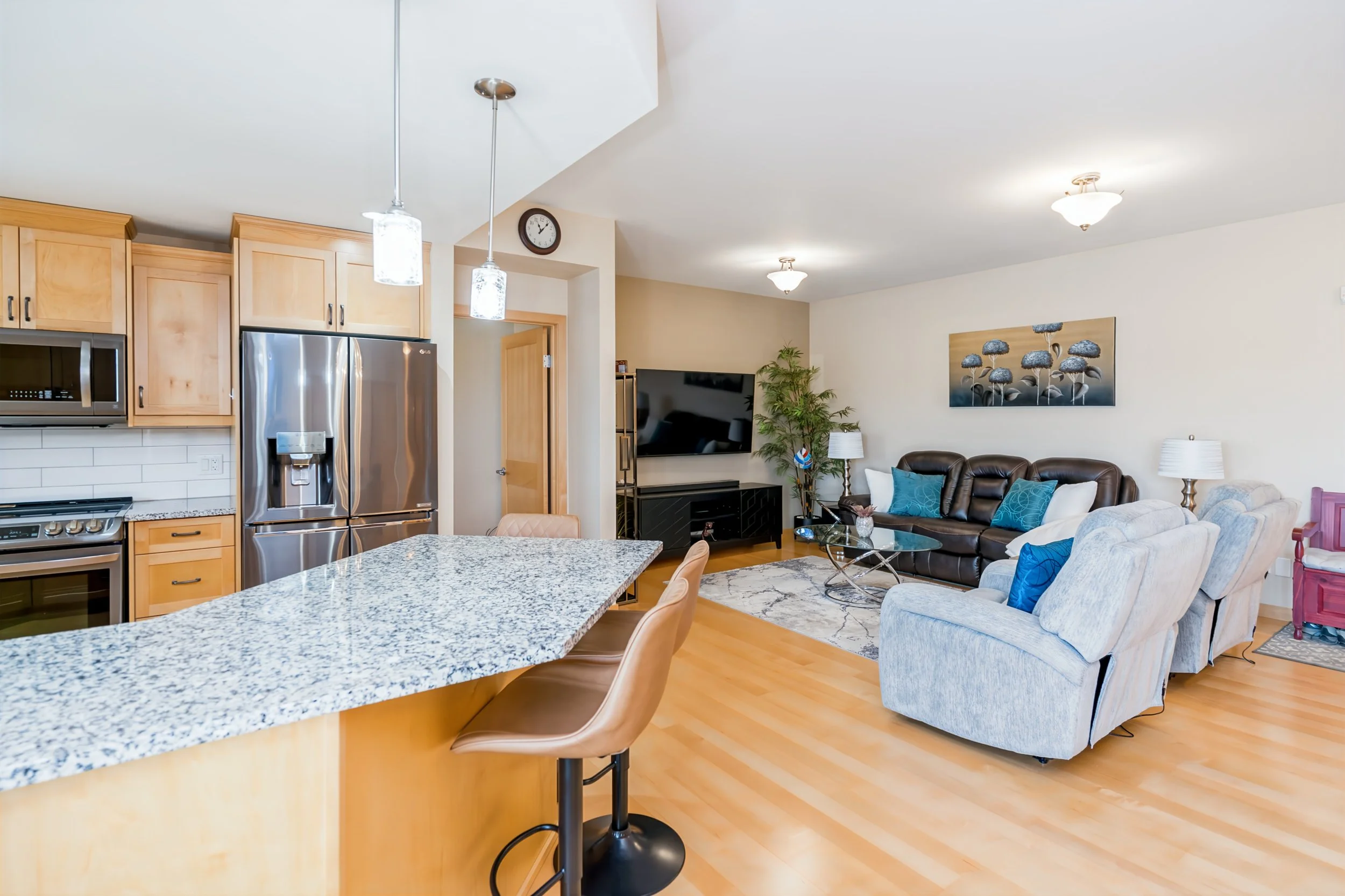 006 Open-concept kitchen with maple cabinetry and granite countertops.jpg