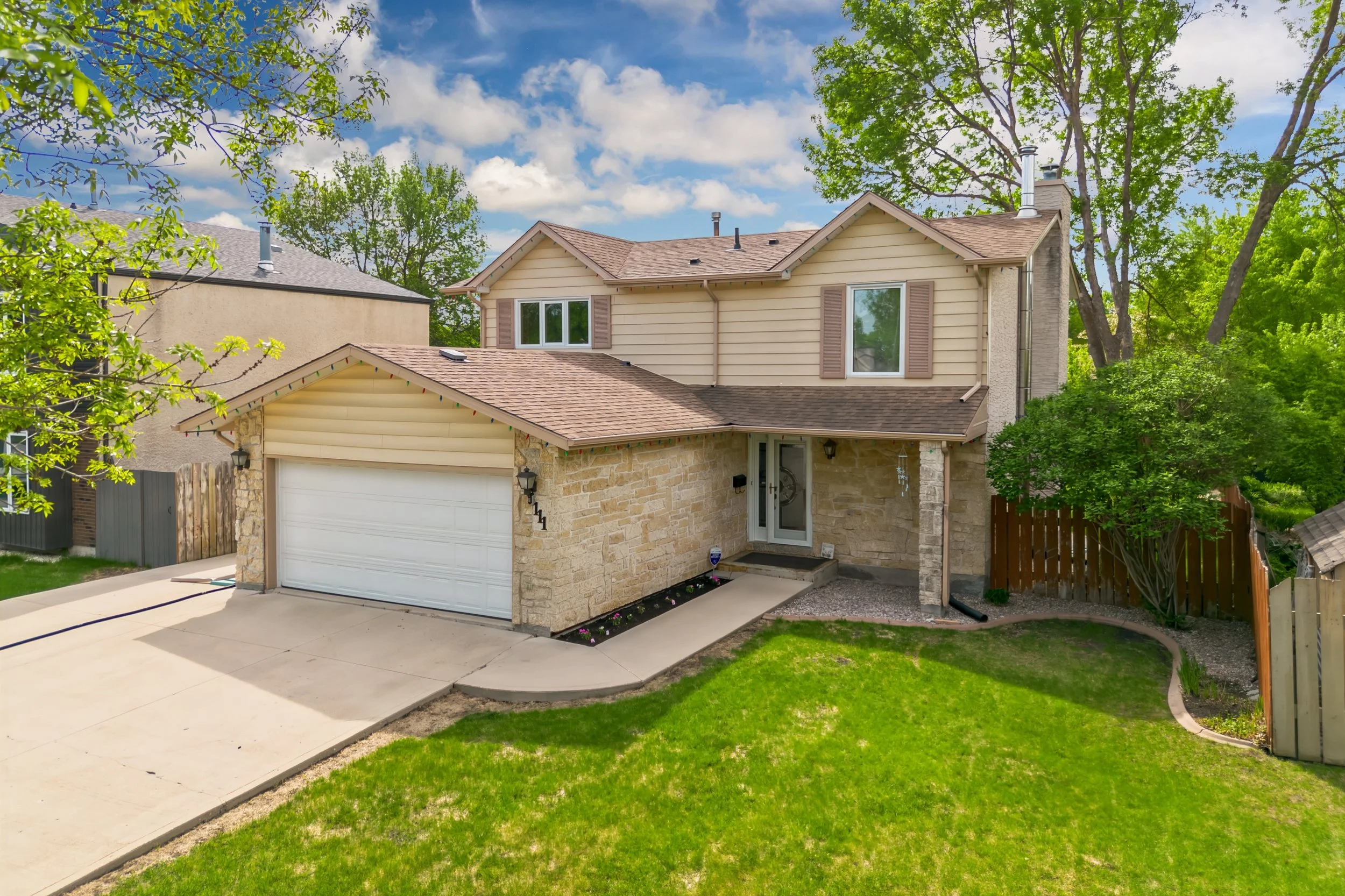 001 Front exterior of Oakwood Estates home with double attached garage.jpg