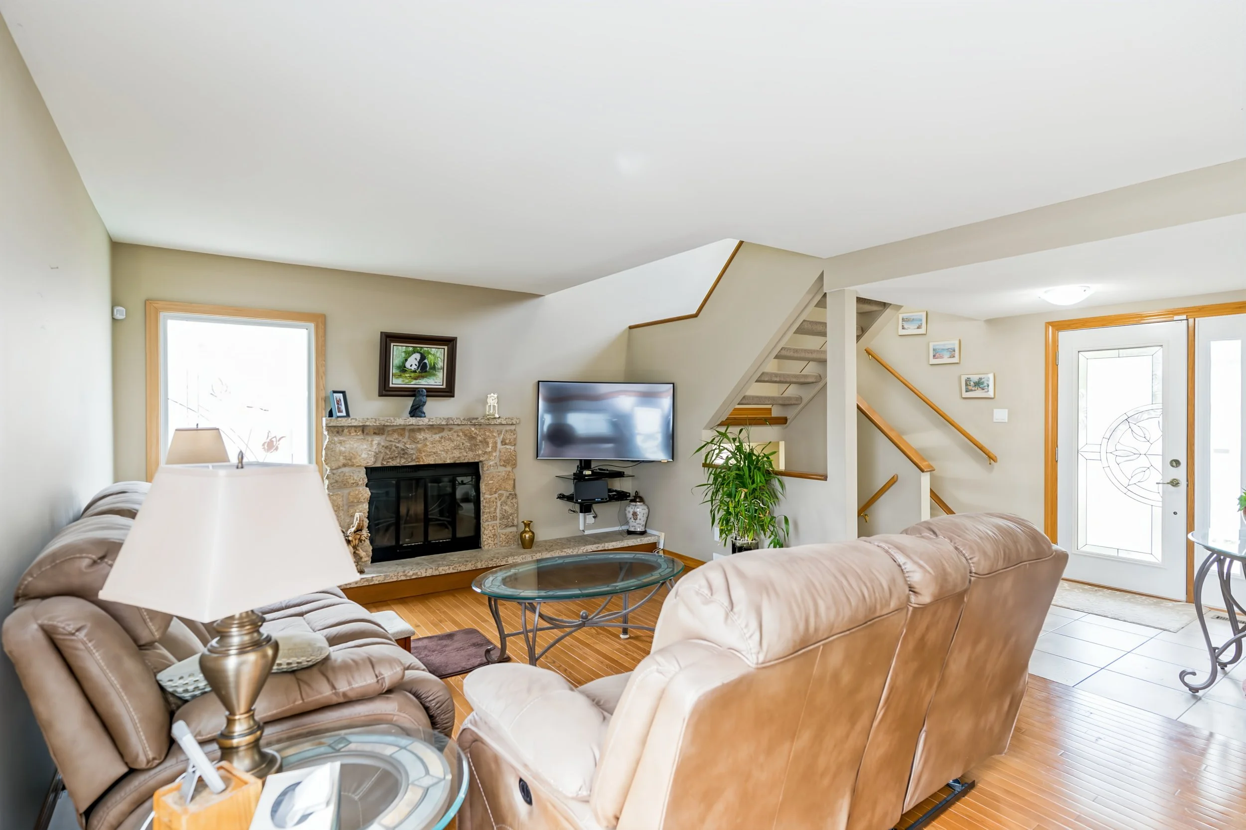 006 Bright living room with oak hardwood floors and wood-burning fireplace.jpg