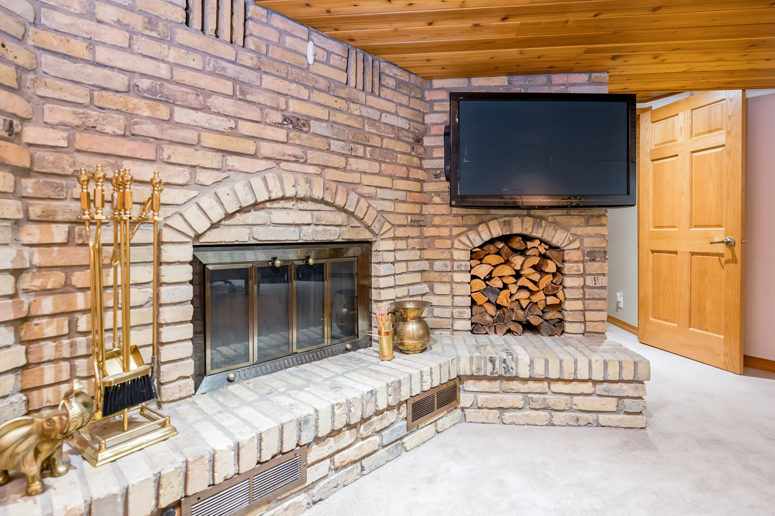 035 Finished basement rec room with wood burning fireplace.jpg