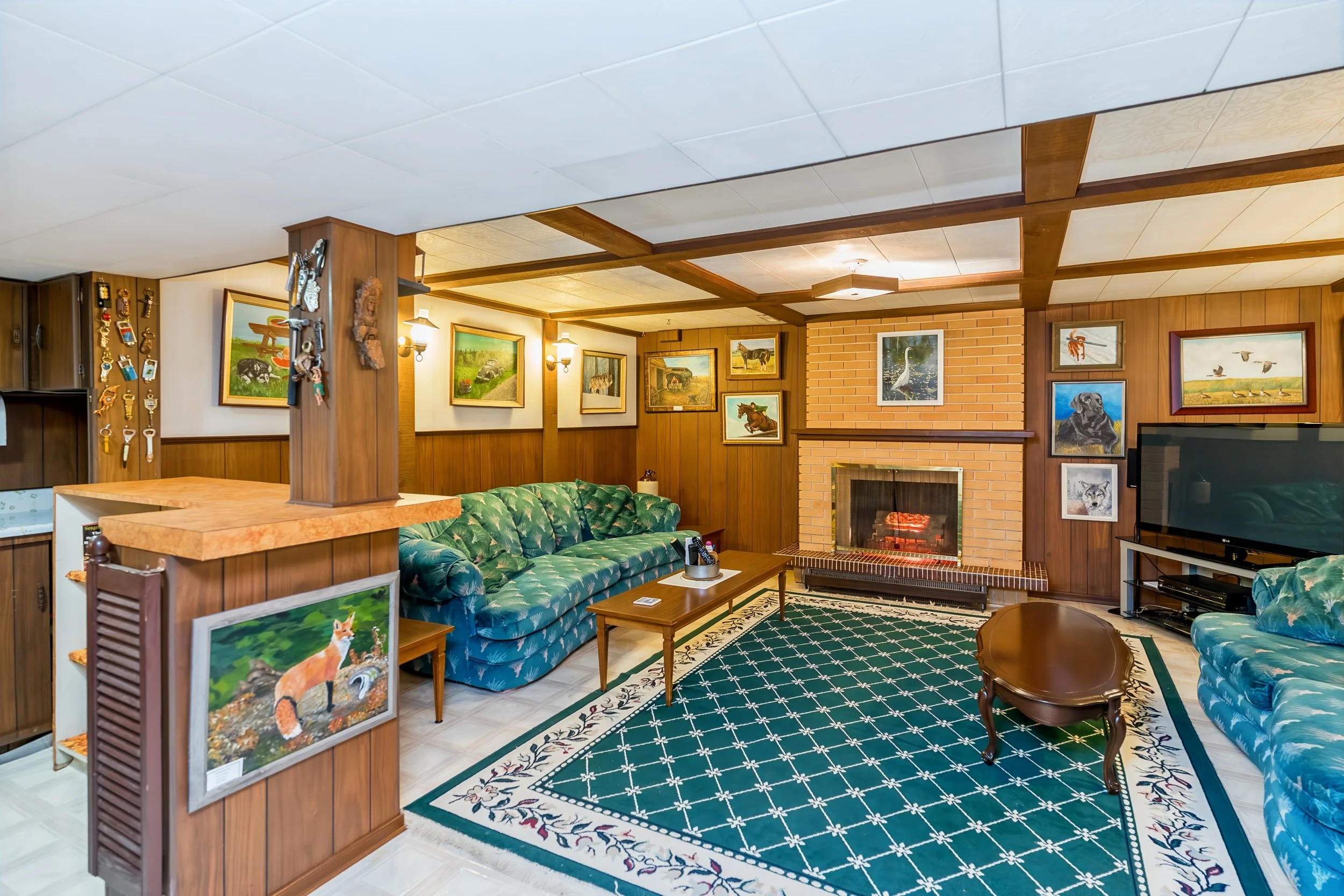 021 Finished basement rec room with electric fireplace at 34 Laurentia Bay.jpg
