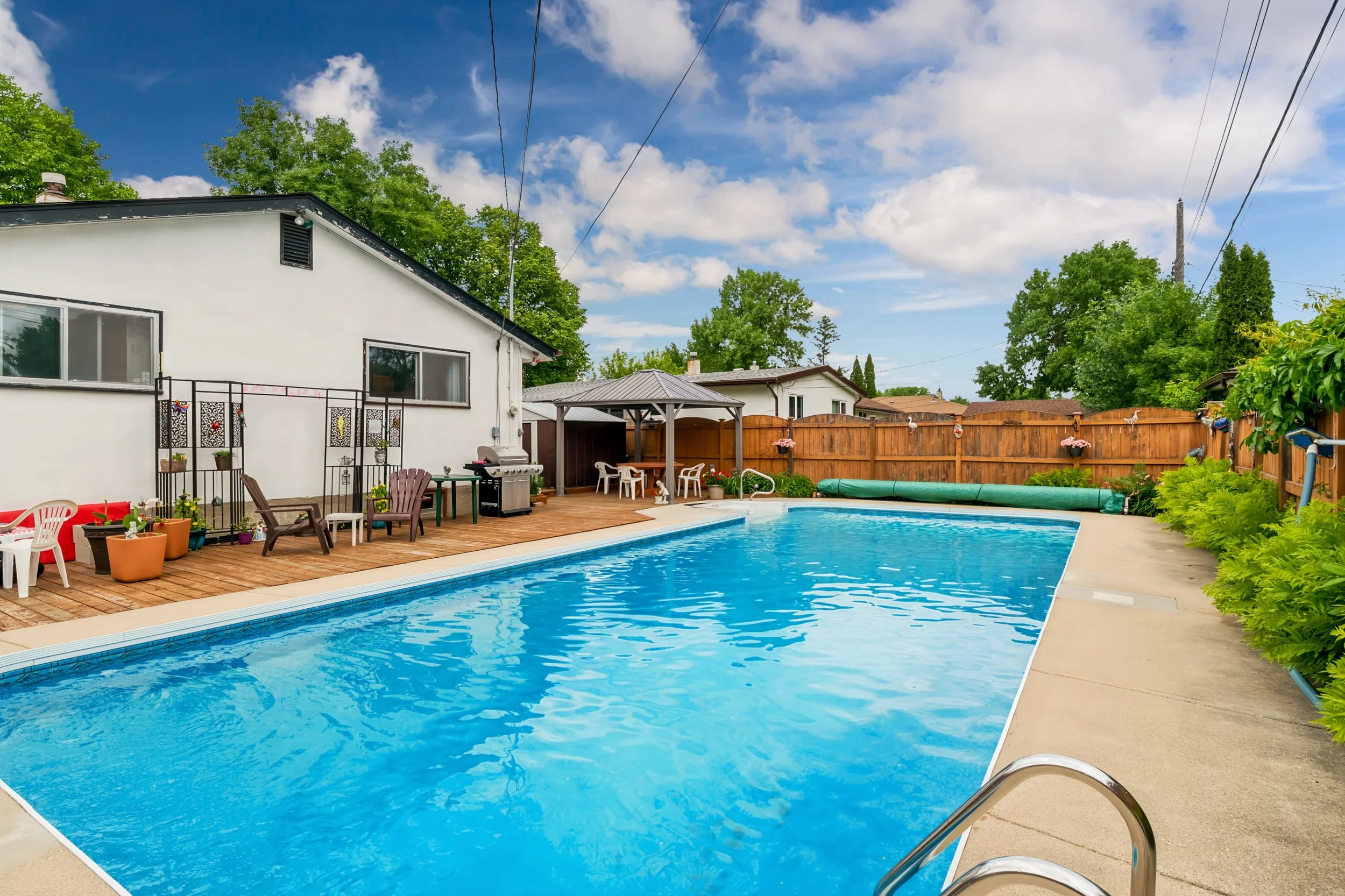033 Backyard entertaining space with inground pool in East Transcona.jpg