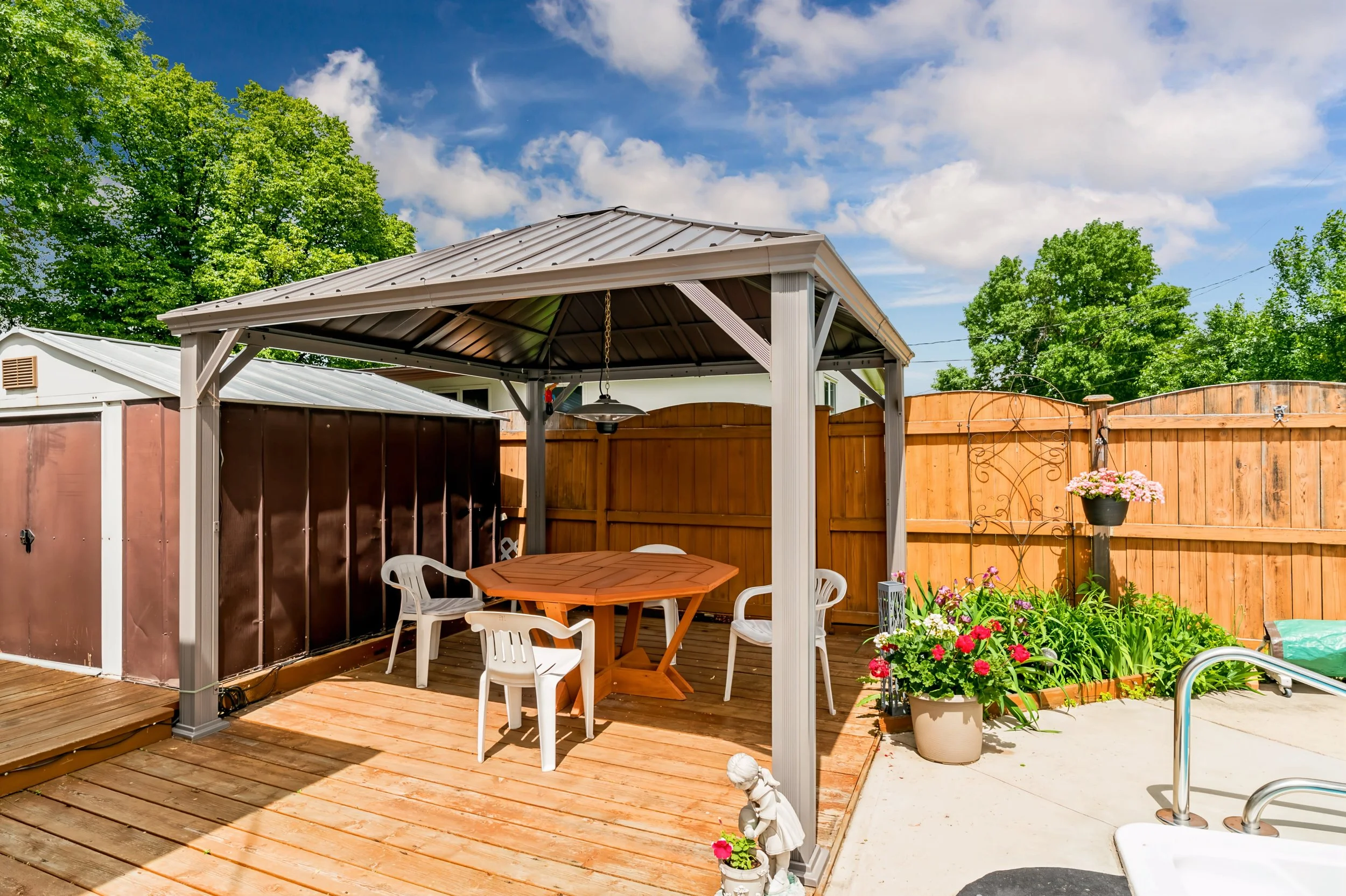 034 Private backyard with mature flower beds and inground pool in Winnipeg.jpg