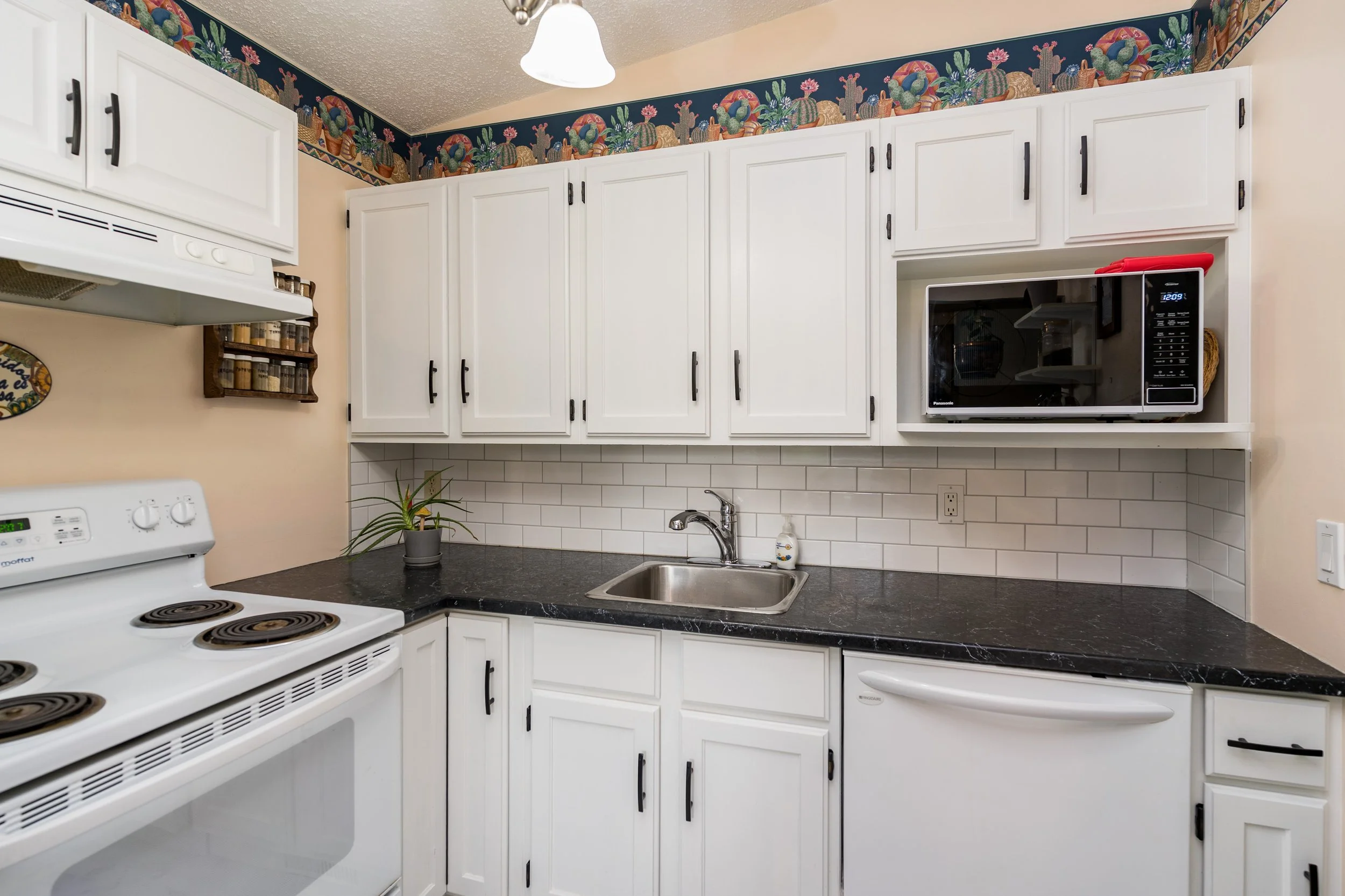 012 Updated kitchen with white cabinets and modern finishes.jpg