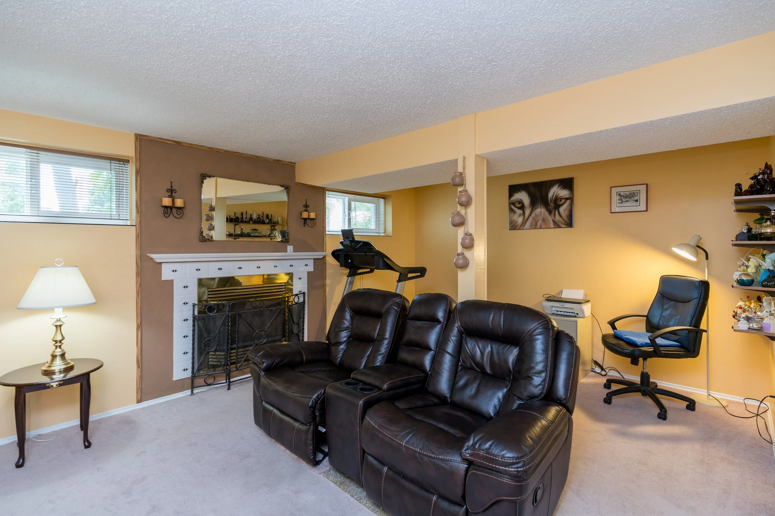 021 Finished basement rec room with cozy gas fireplace.jpg