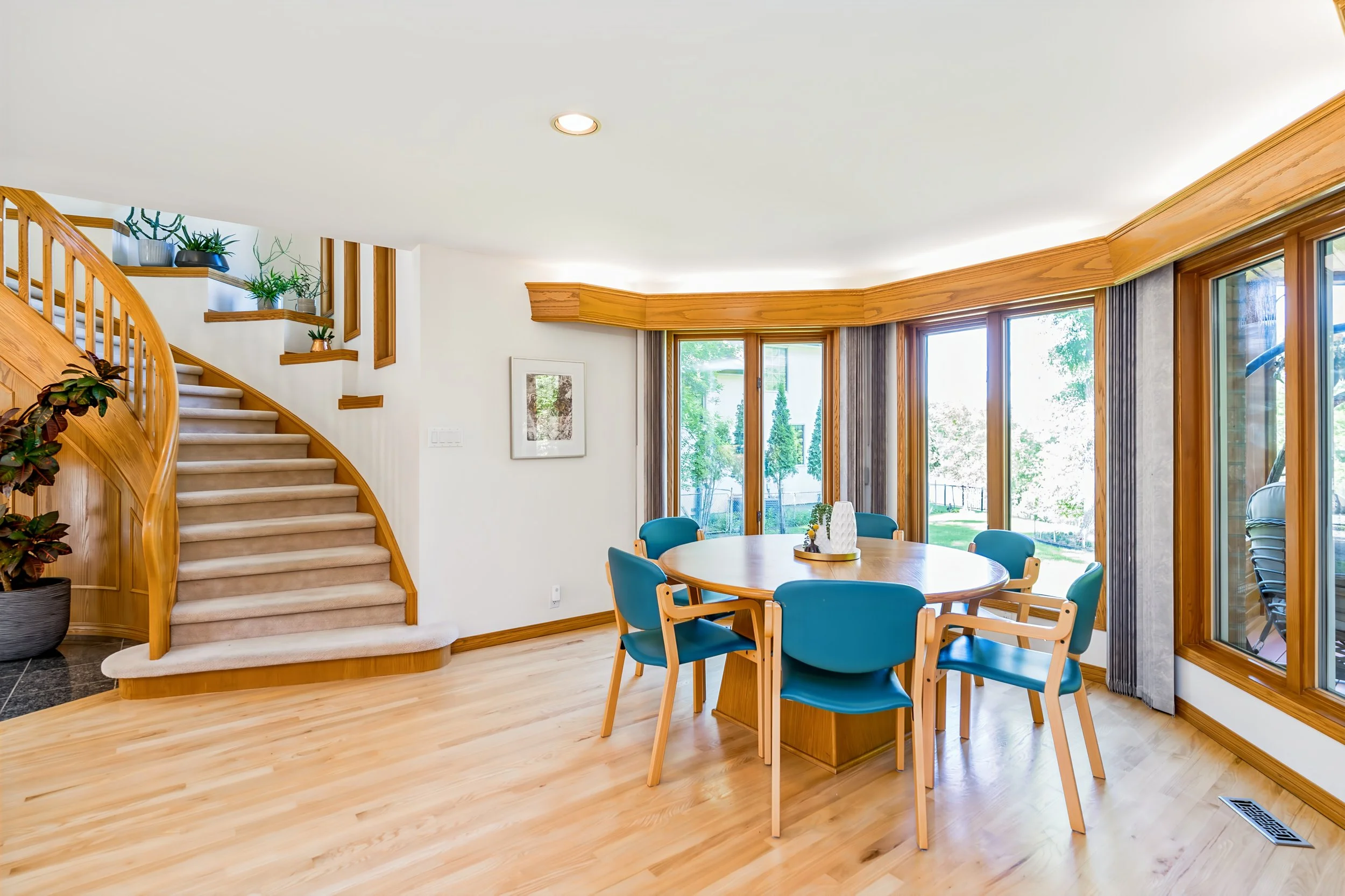 024 Breakfast area with views of mature trees and backyard.jpg