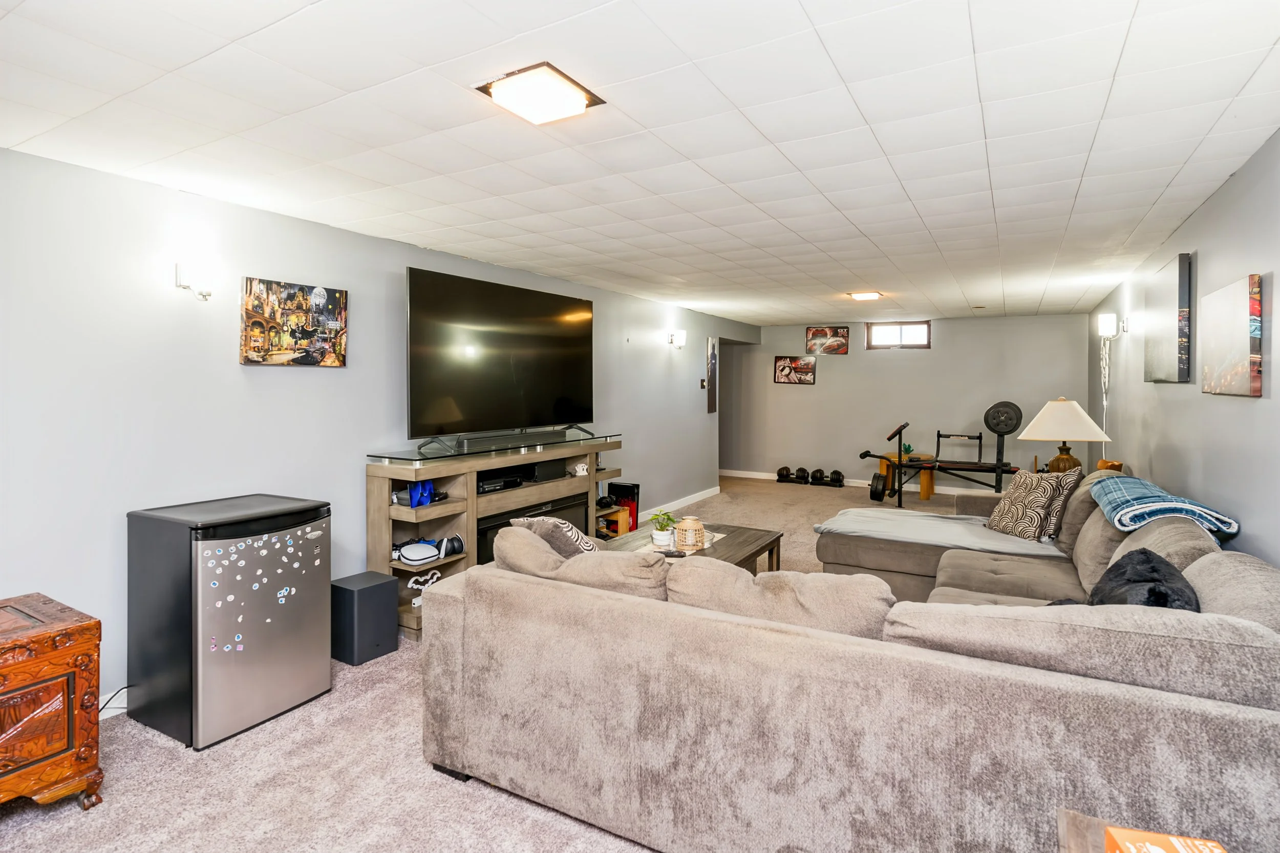 023 Basement rec room with Tyndall stone feature fireplace.jpg