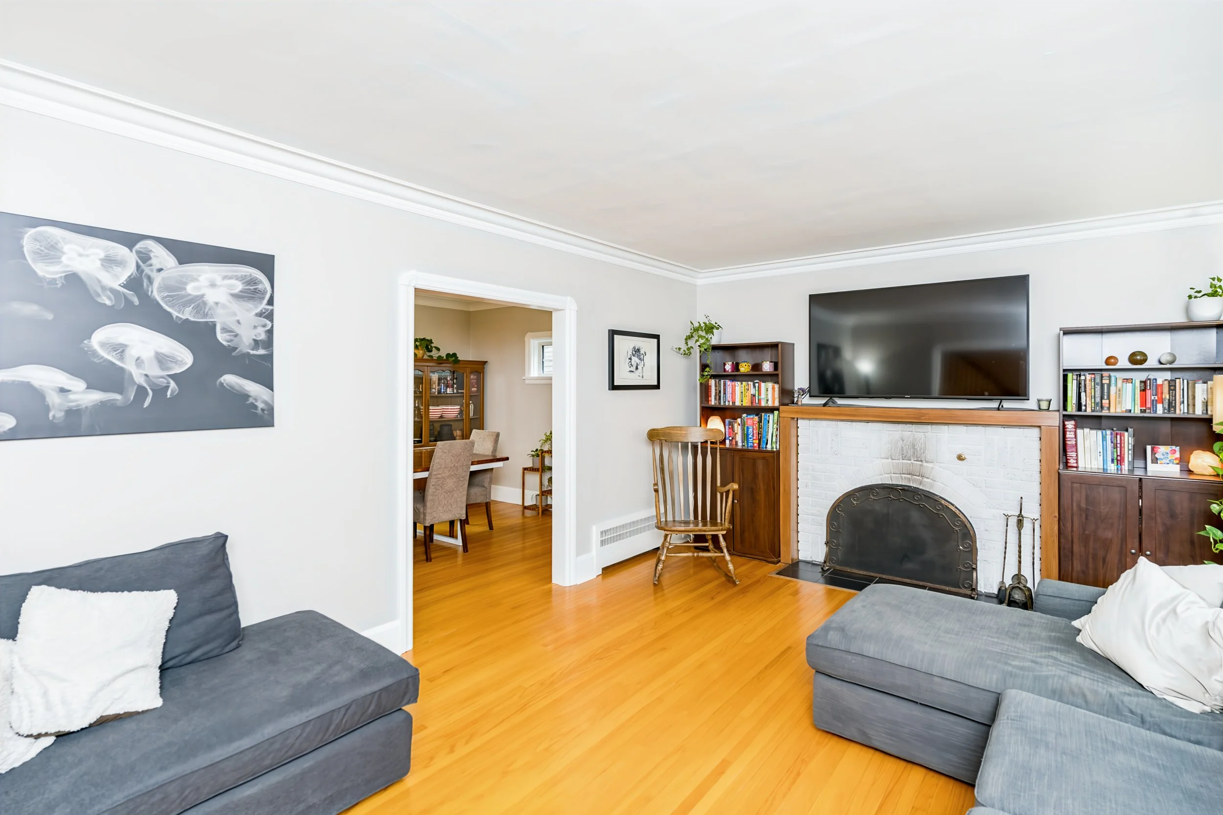 004 Living room with wood-burning fireplace in East Fort Garry home.jpg