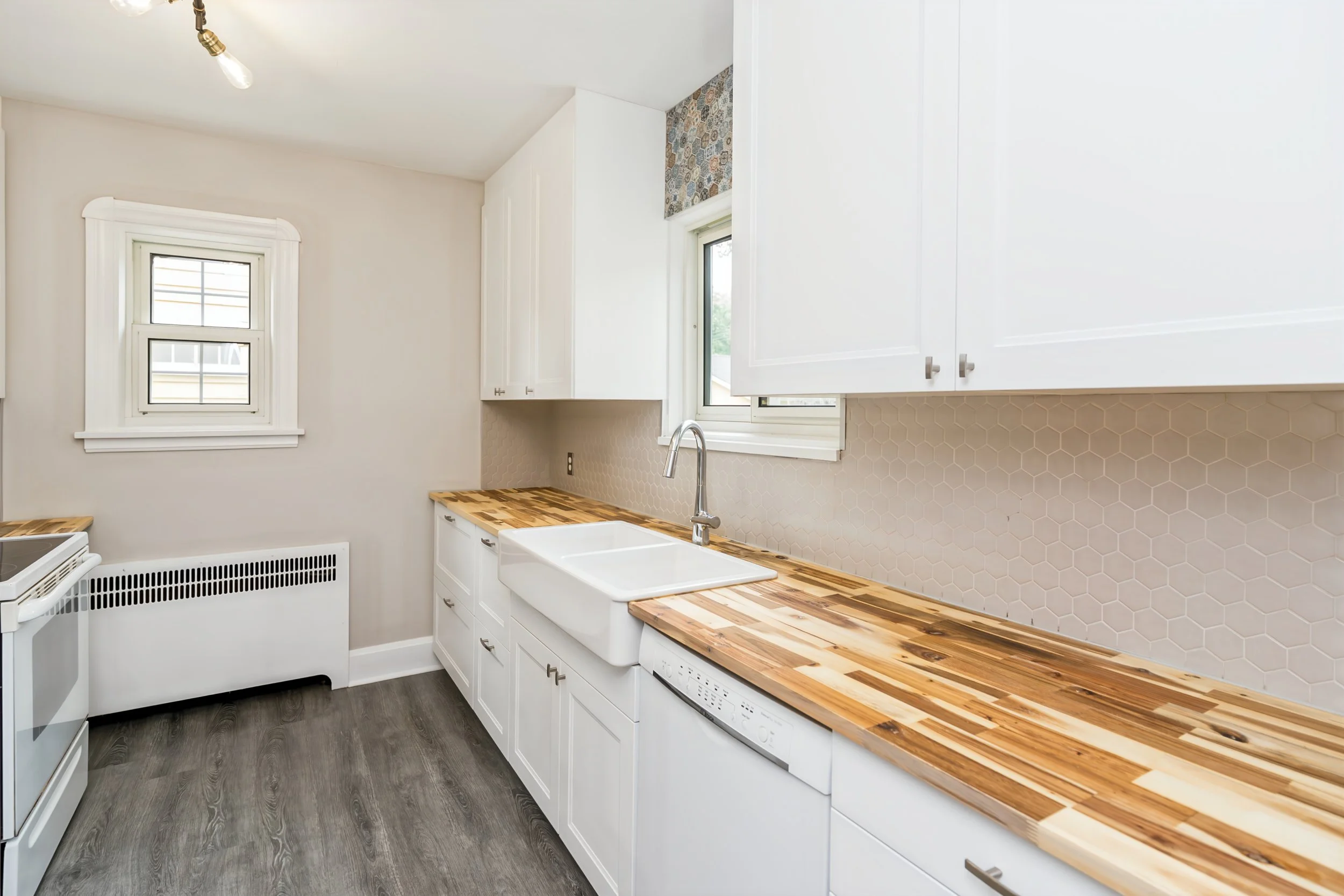 018 Updated kitchen with white shaker-style cabinetry.jpg