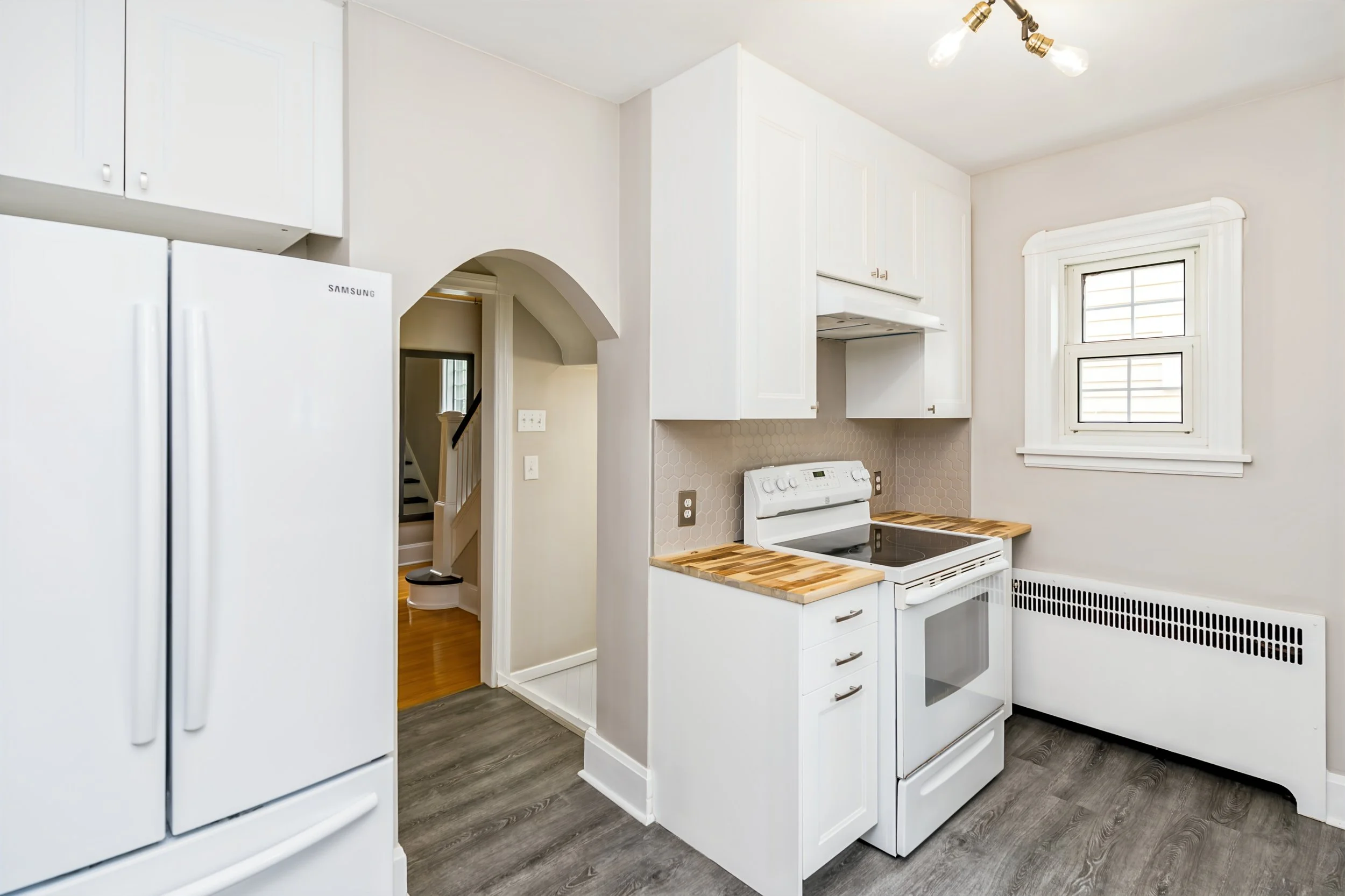 022 White kitchen cabinetry and functional counter space.jpg