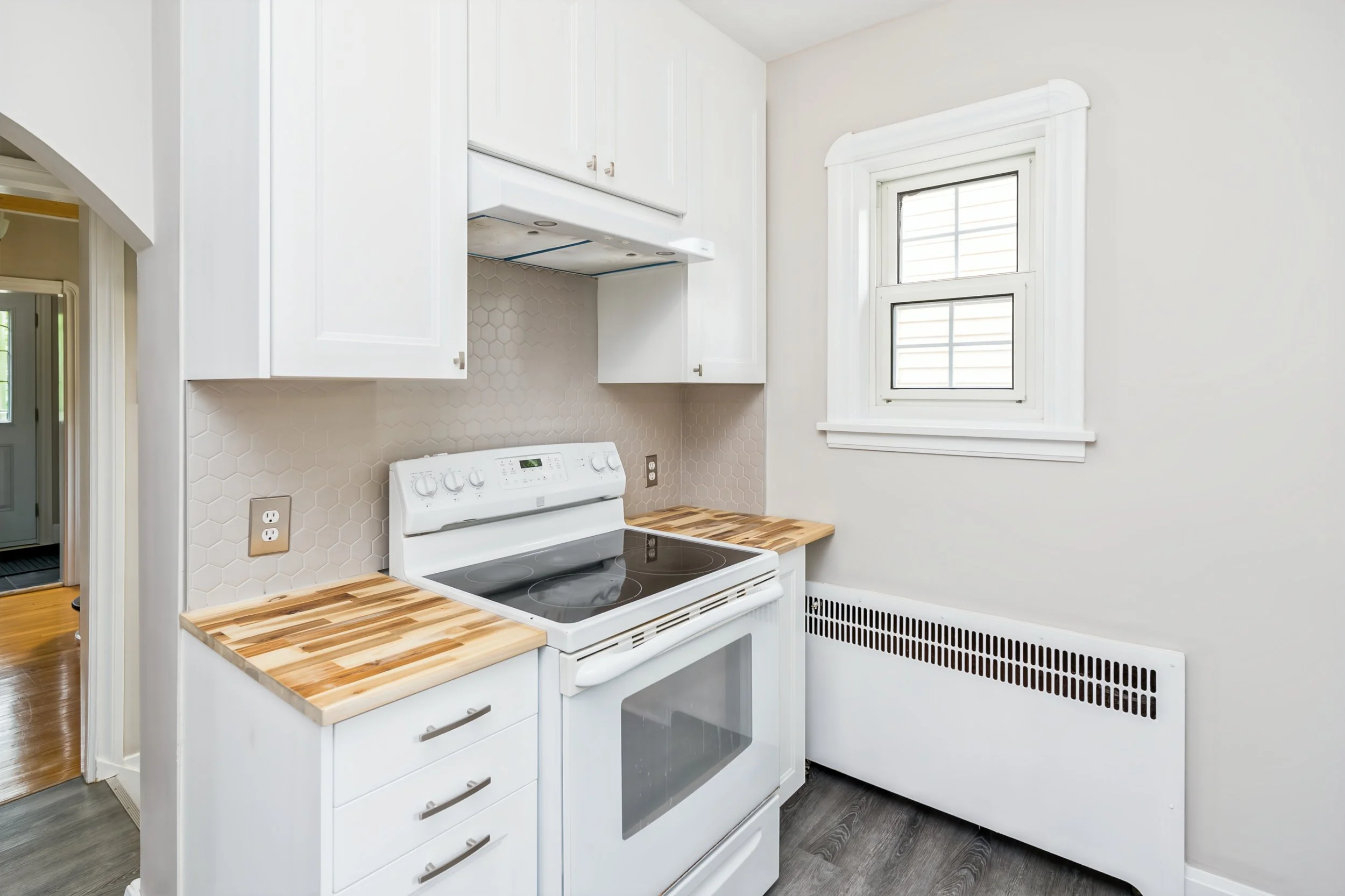 024 Main floor kitchen with stylish tile backsplash.jpg