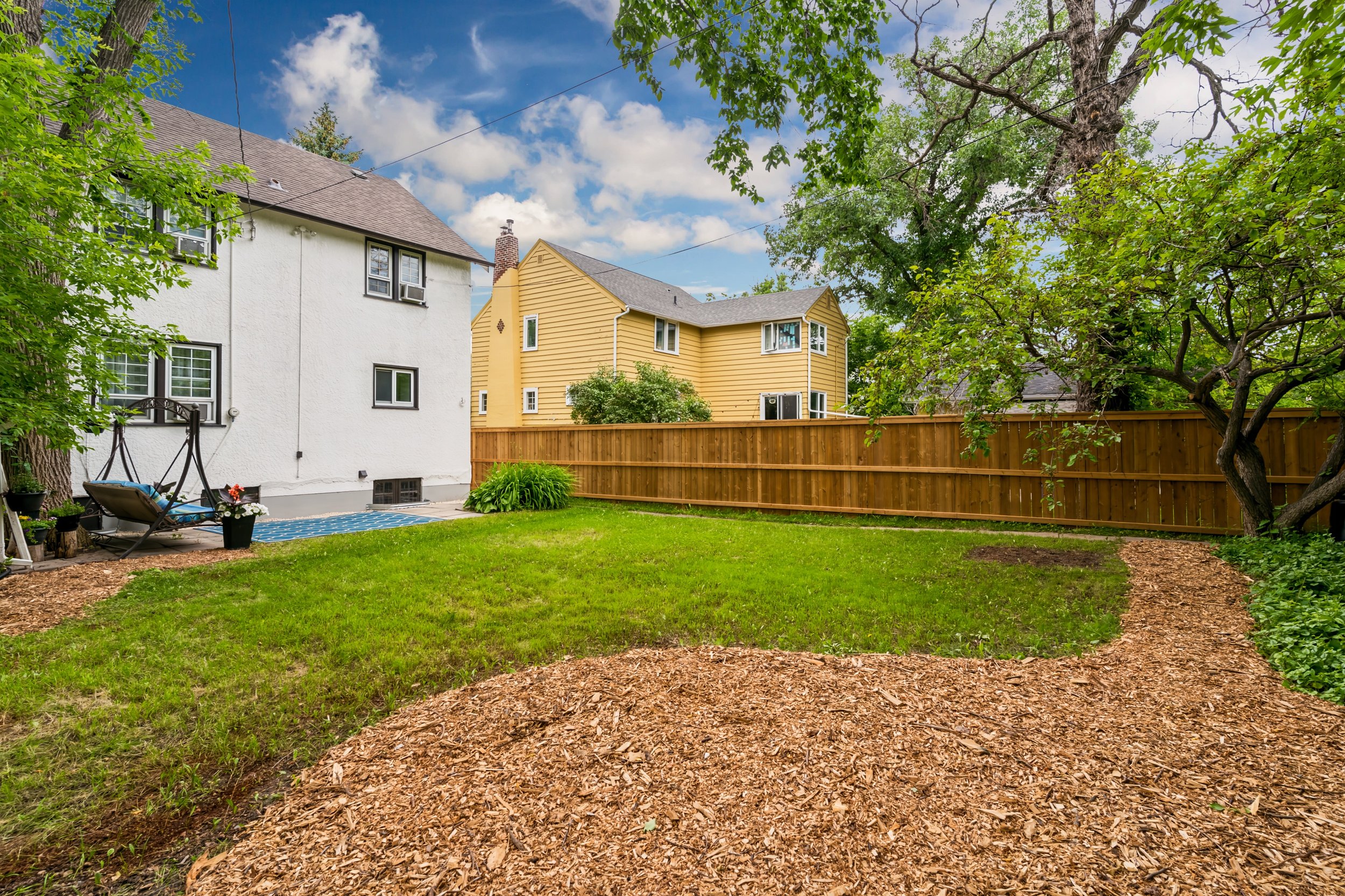 057 Backyard surrounded by mature landscaping.jpg