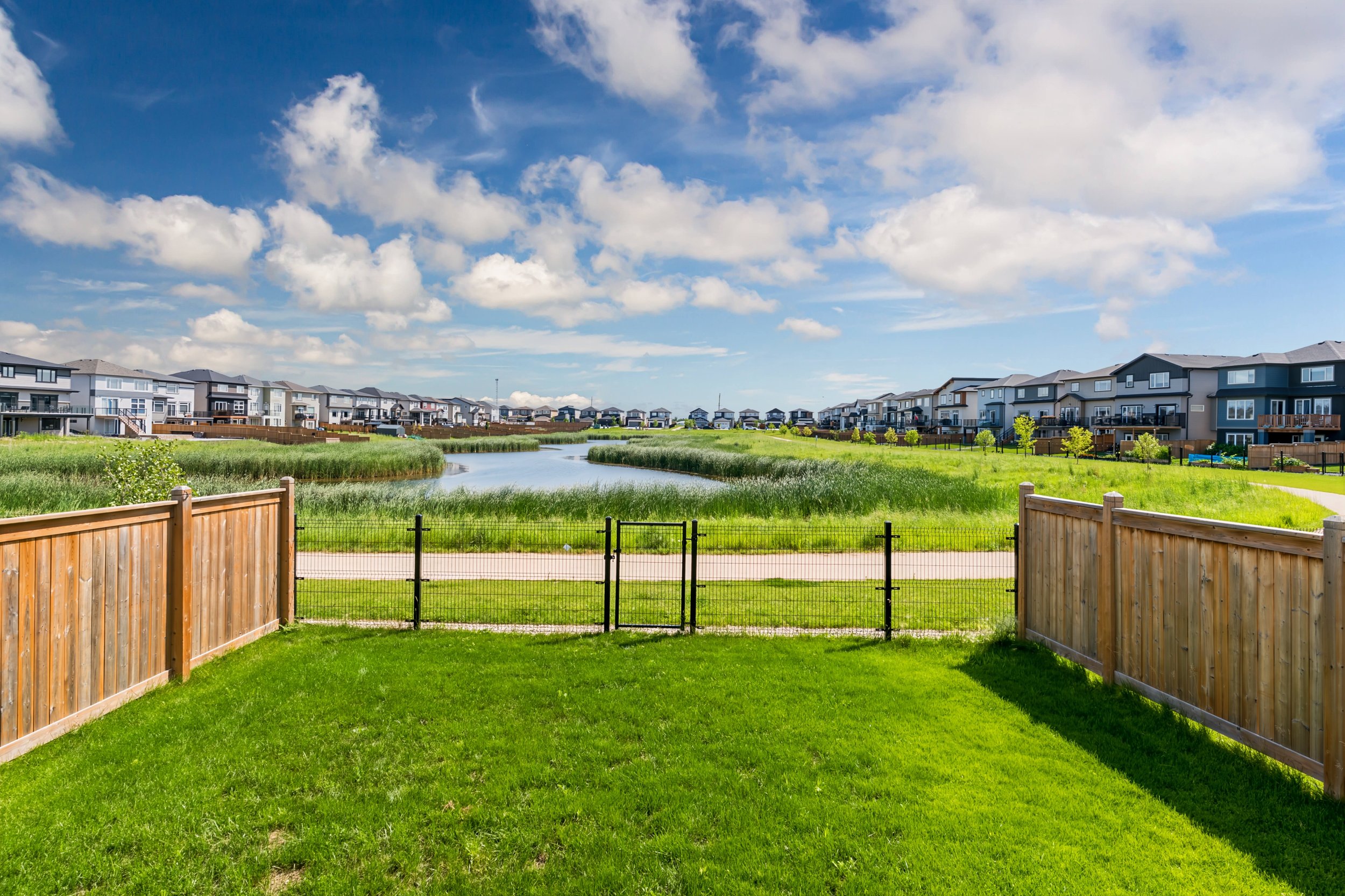 045 fenced backyard overlooking water and walking trail.jpg