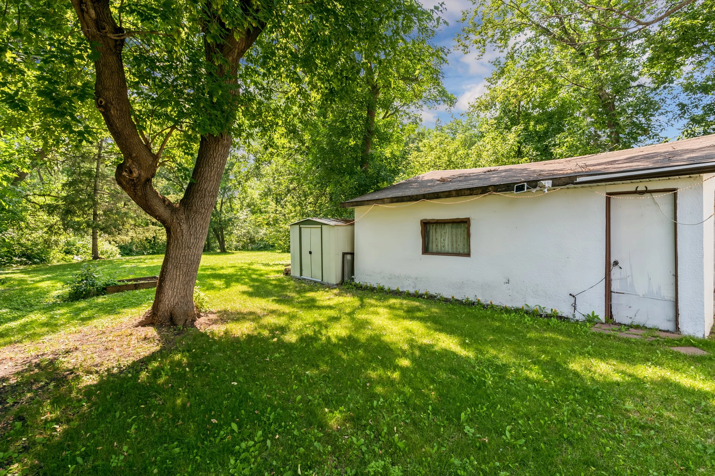 036 Private backyard surrounded by mature greenery in Winnipeg MB.jpg