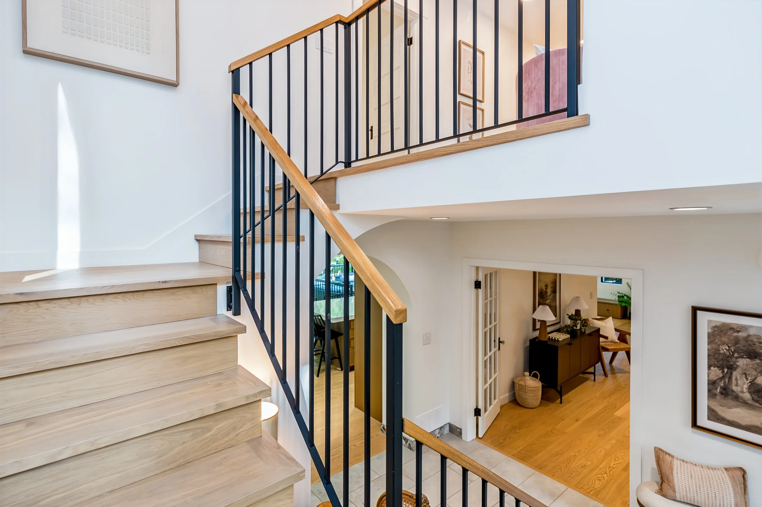 044 Custom staircase with ornamental bannister at 409 North Drive.jpg