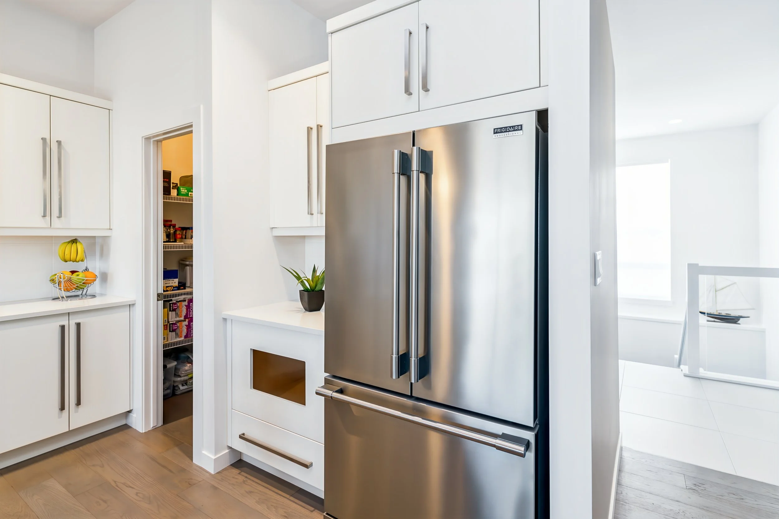 010 Kitchen with tiled backsplash and walk-in pantry.jpg