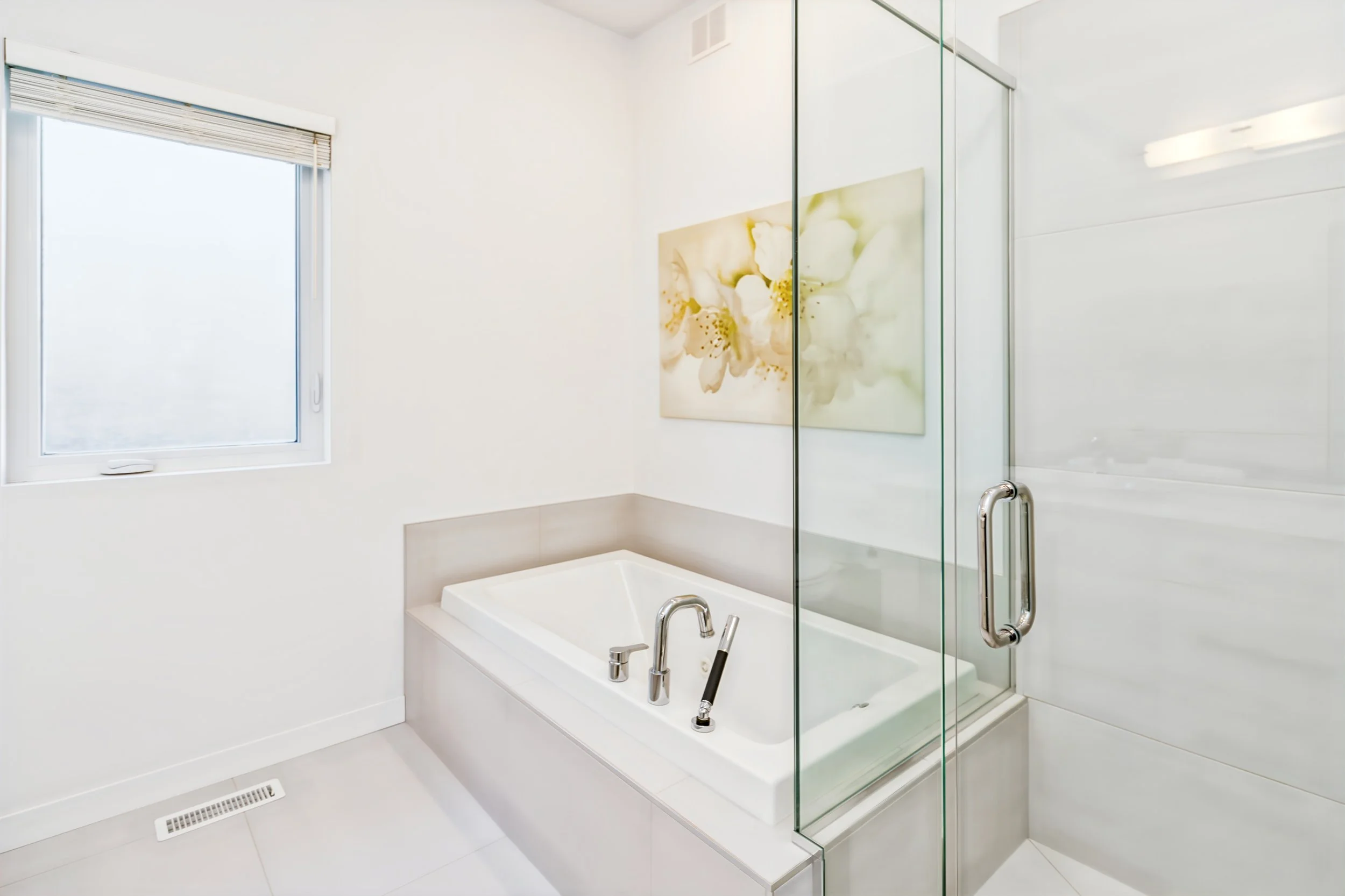 023 Ensuite bathroom with soaker tub and tiled shower.jpg