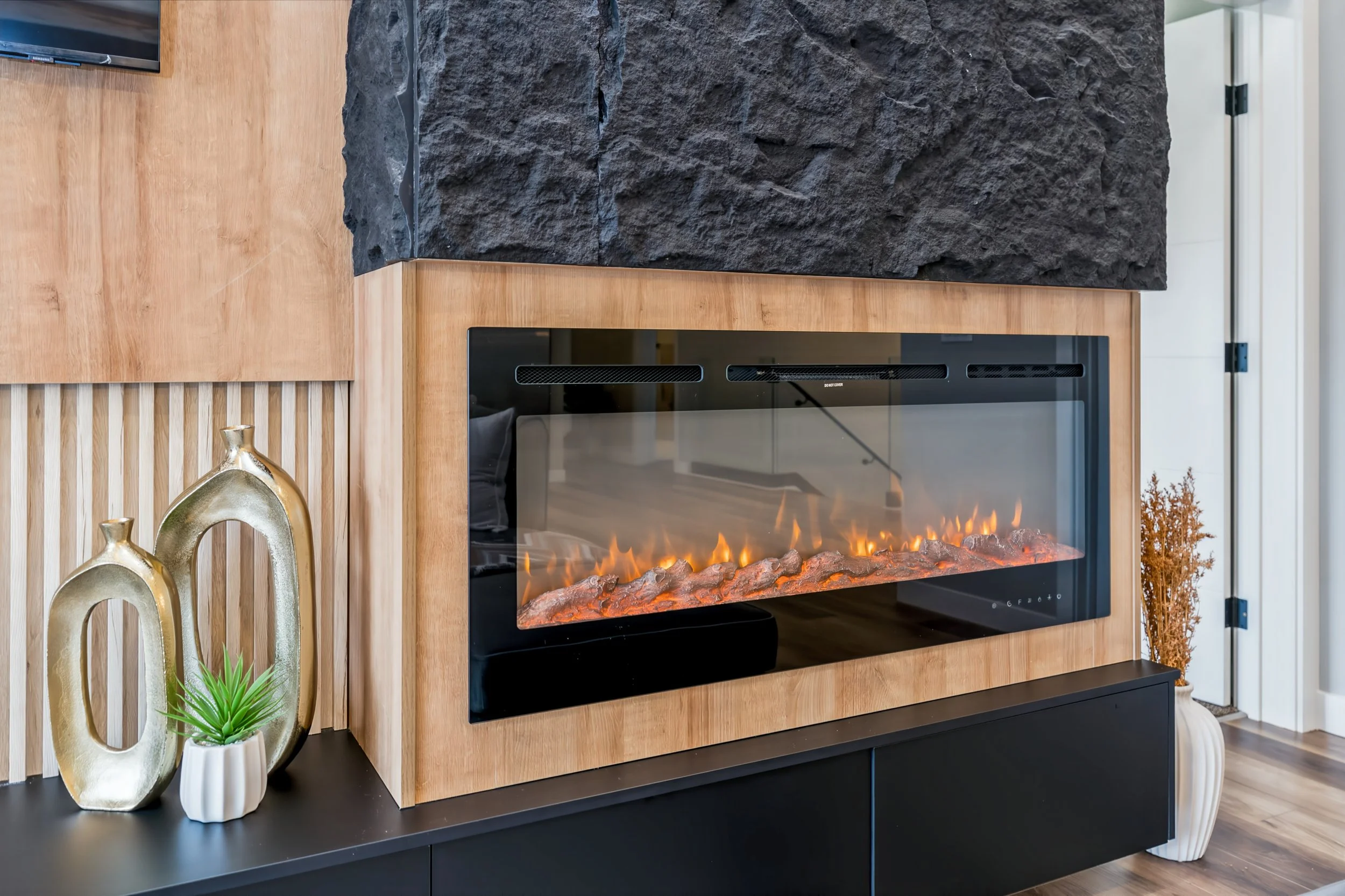 010 Main-floor electric fireplace beneath the soaring ceiling..jpg