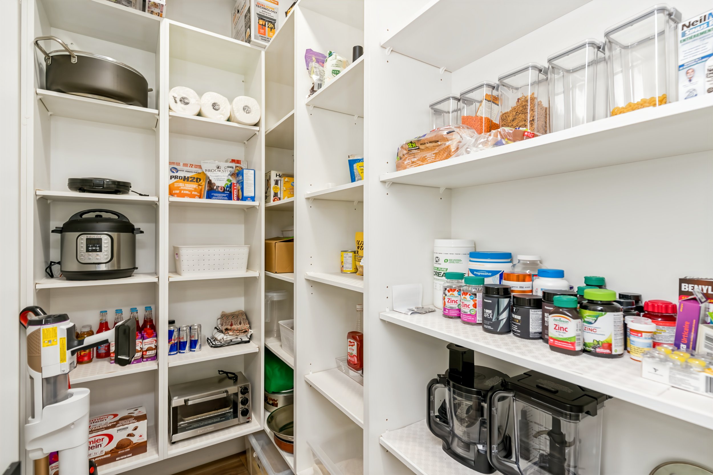 033 Walk-in pantry providing storage beside the spice kitchen..jpg