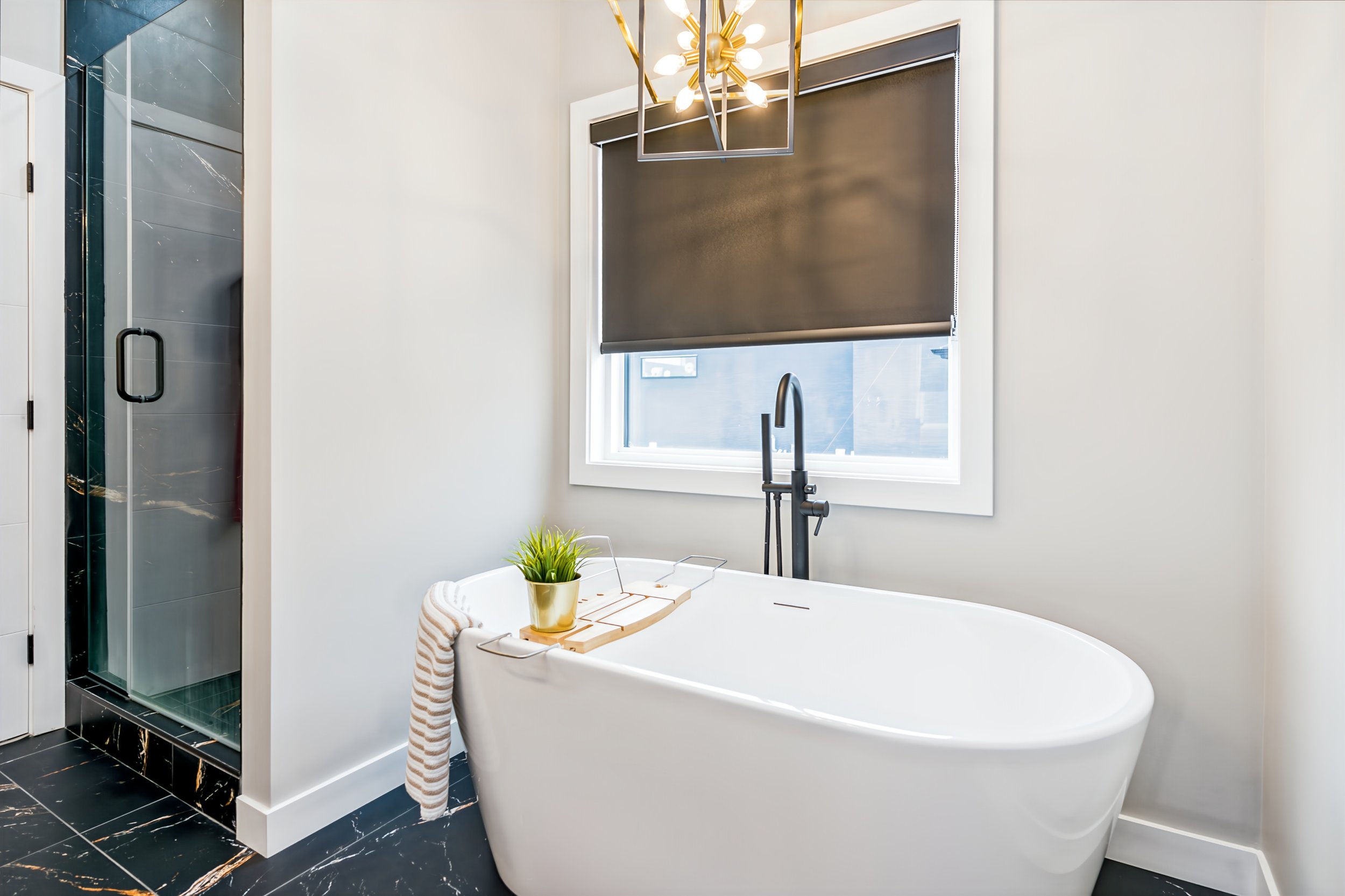040 Freestanding tub beside the primary bathroom’s double-sink vanity..jpg