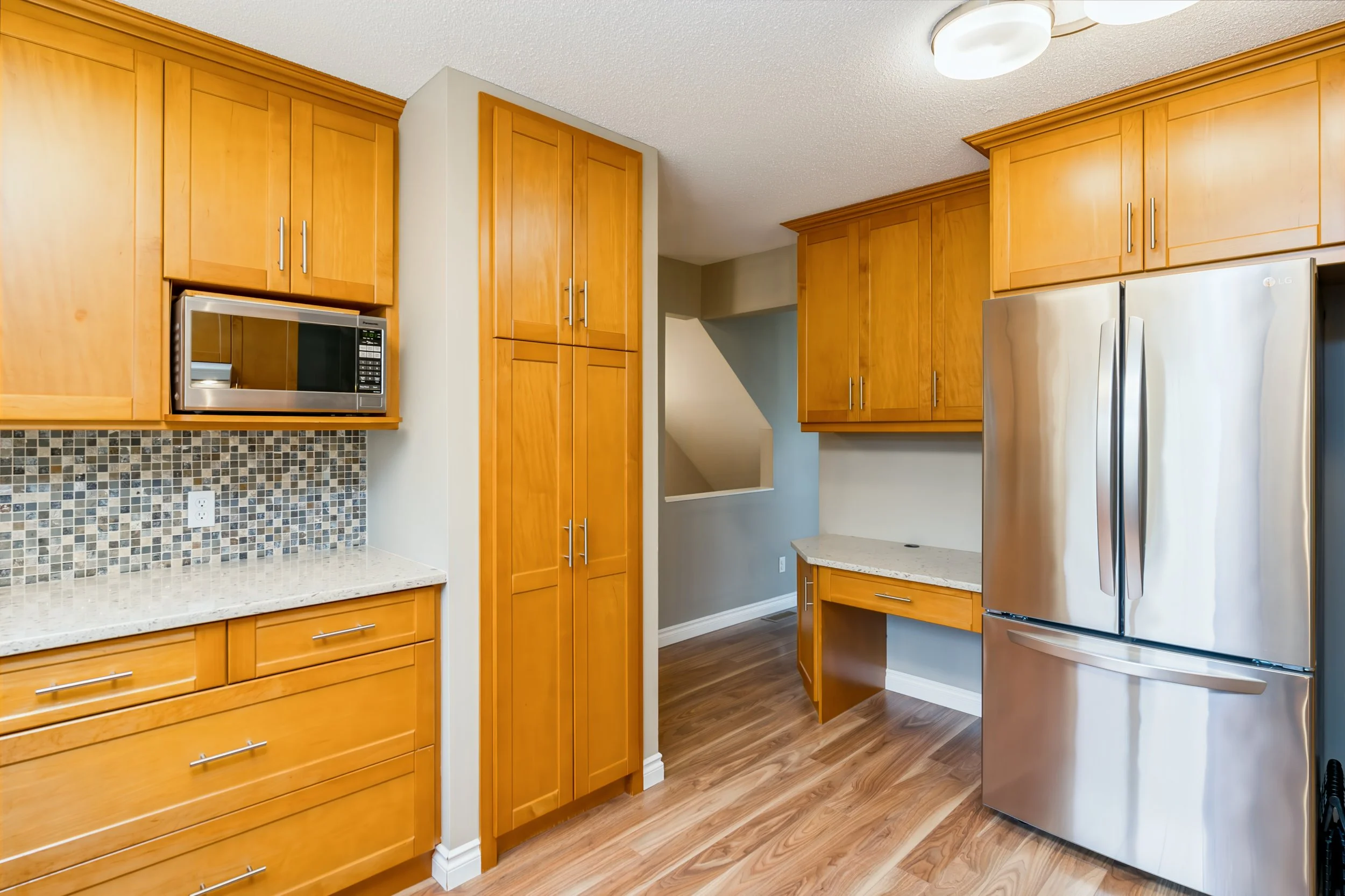 009 Upper maple cabinetry providing kitchen storage..jpg