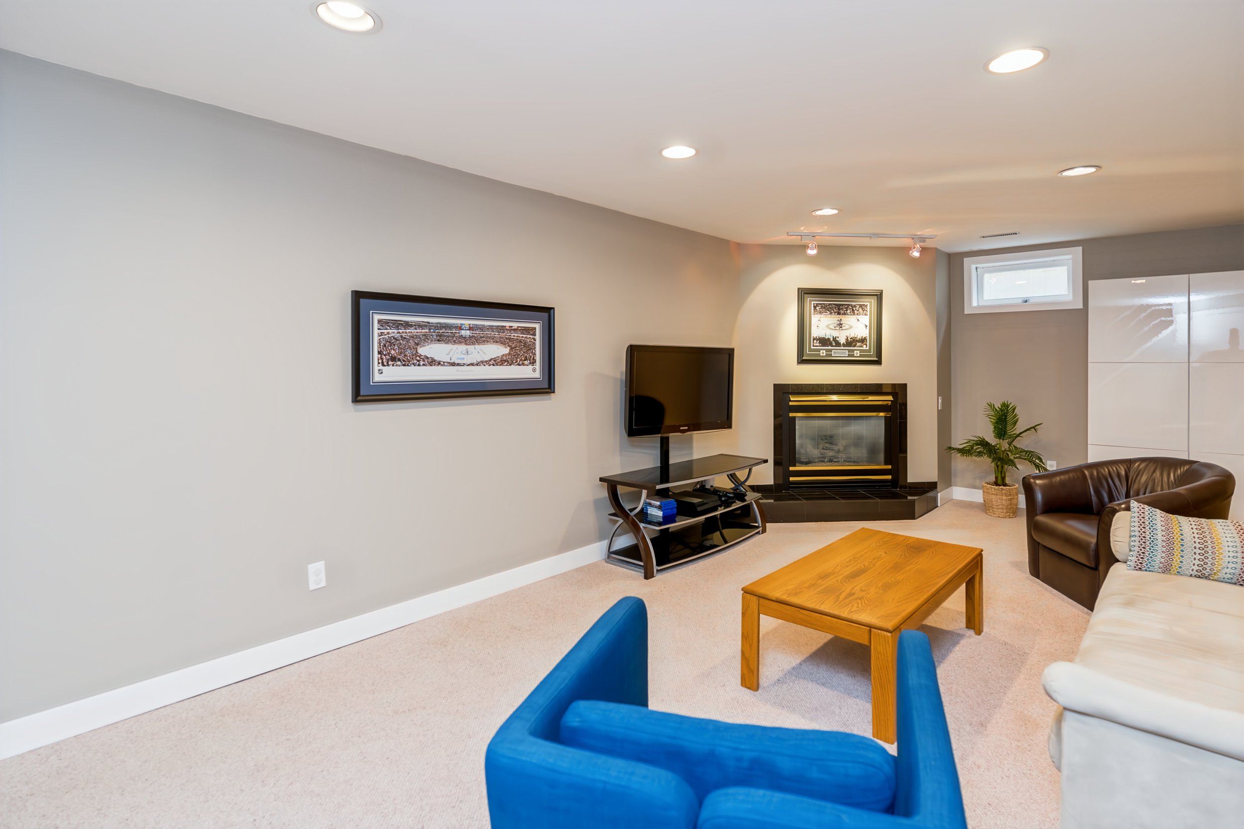 033 Basement gathering area with a cozy gas fireplace..jpg
