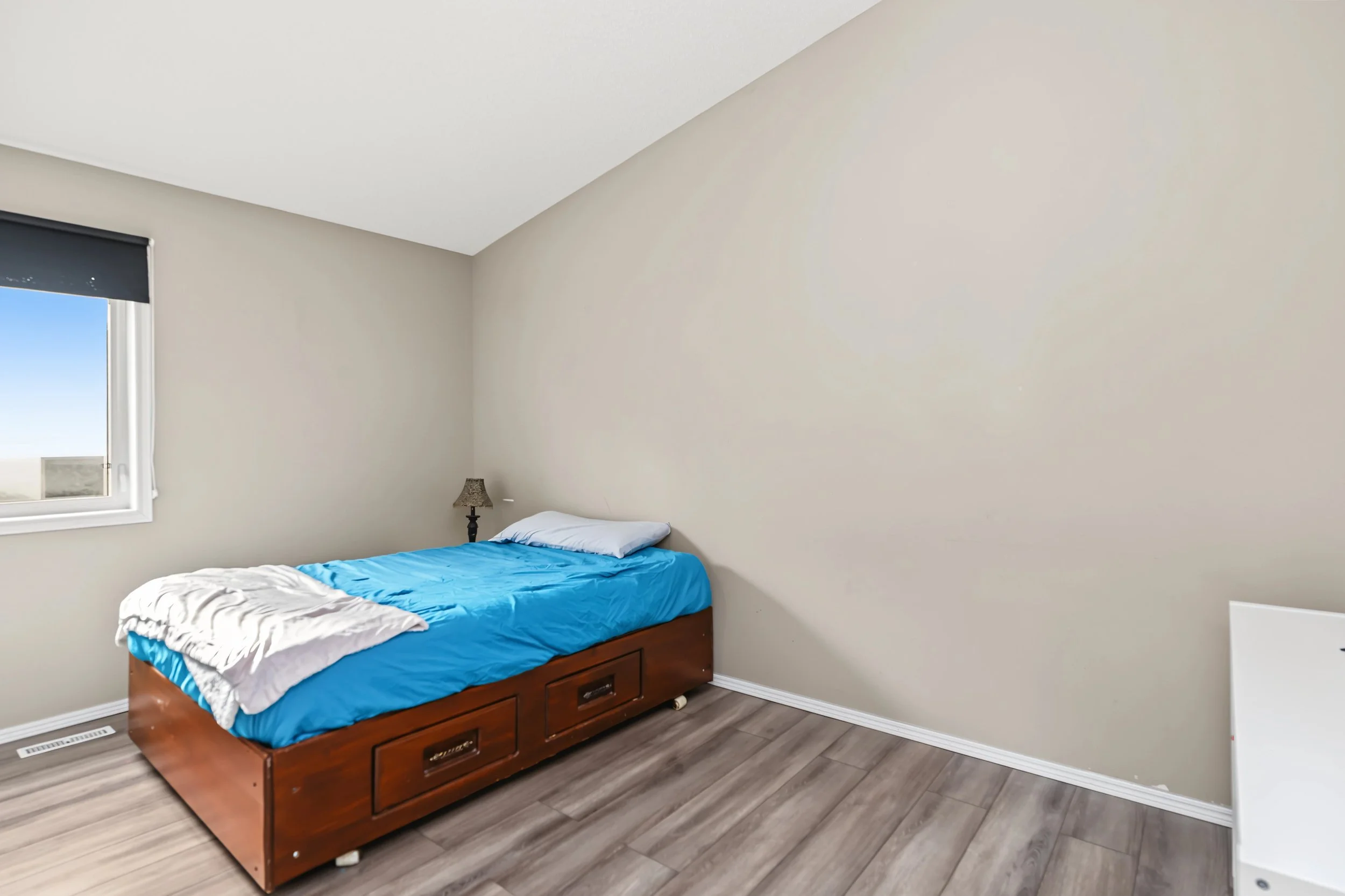 021 Main-floor bedroom in this three-bedroom Canterbury Park home.jpeg