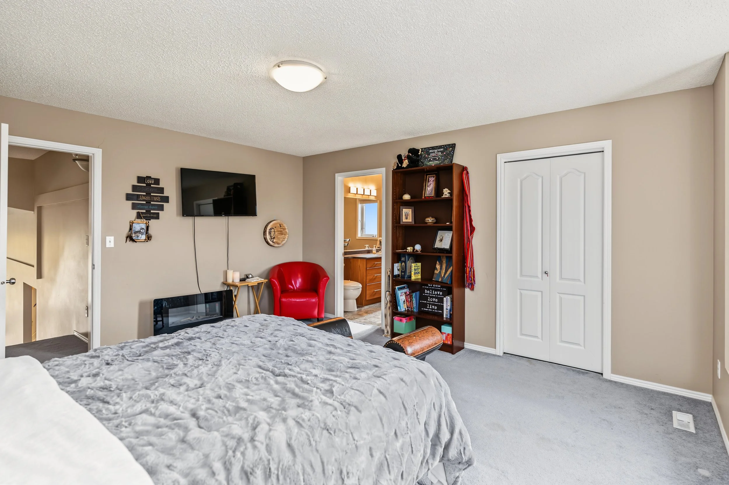029 Primary suite set apart from the main-floor bedrooms.jpeg