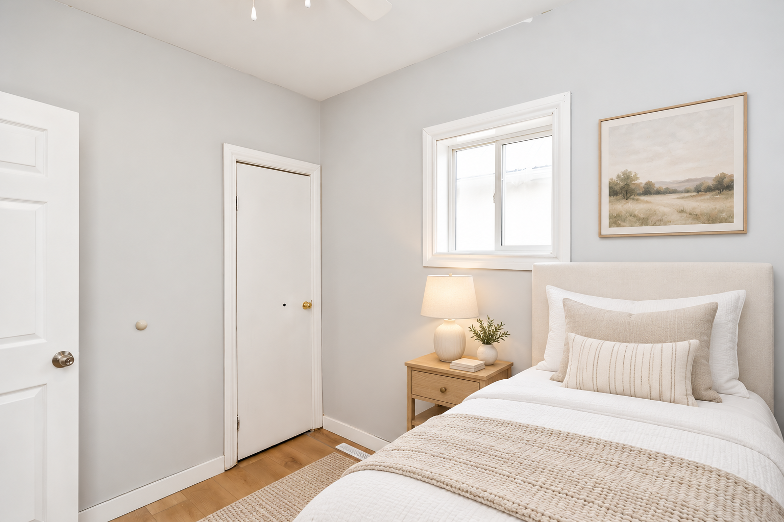 Light-filled small bedroom with a single bed.png
