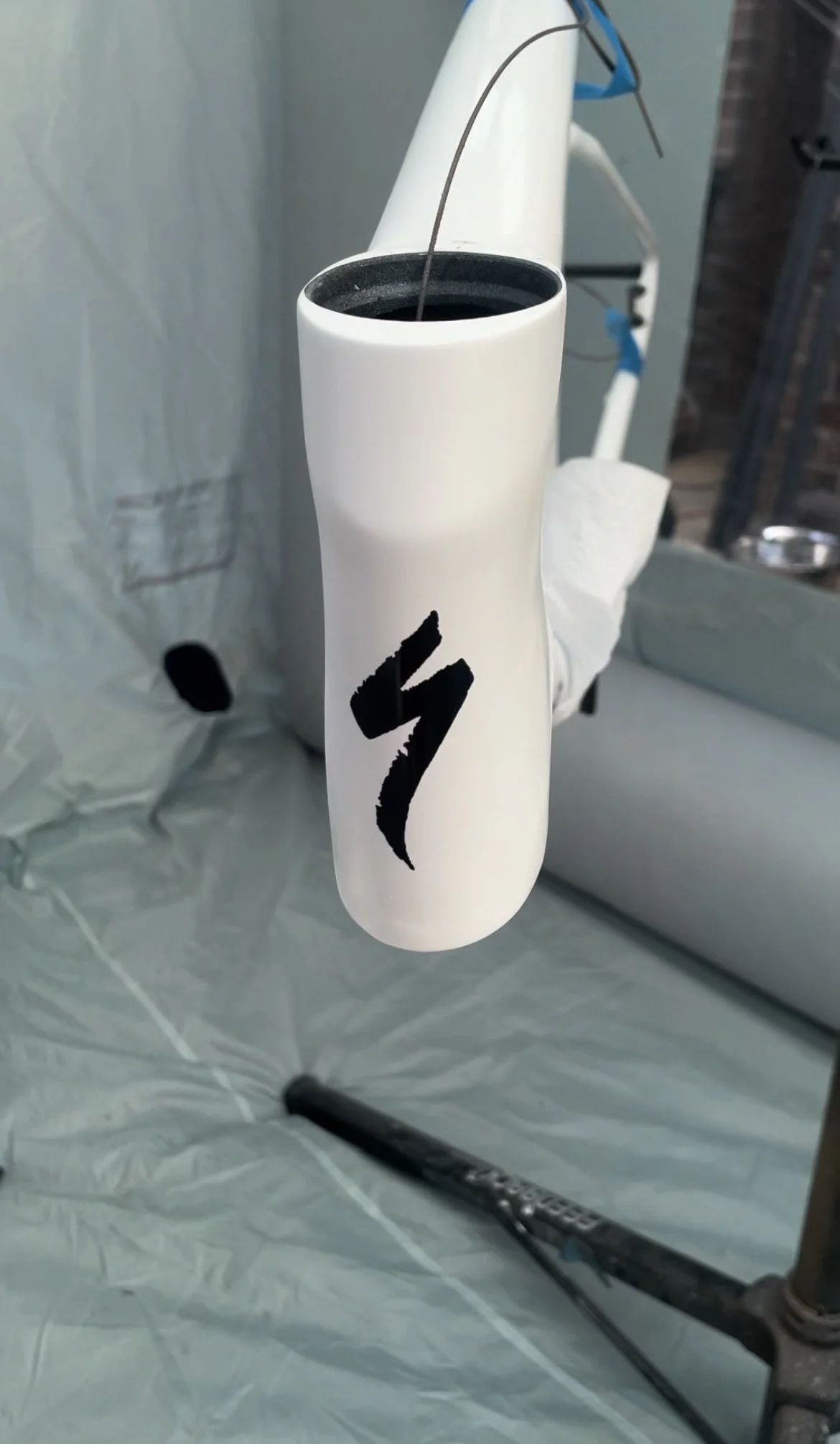 This still shot was grabbed in the paint booth just after clear coat was sprayed, the white had been color matched and blended, and the black Specialized "S" logo was masked off and sprayed 