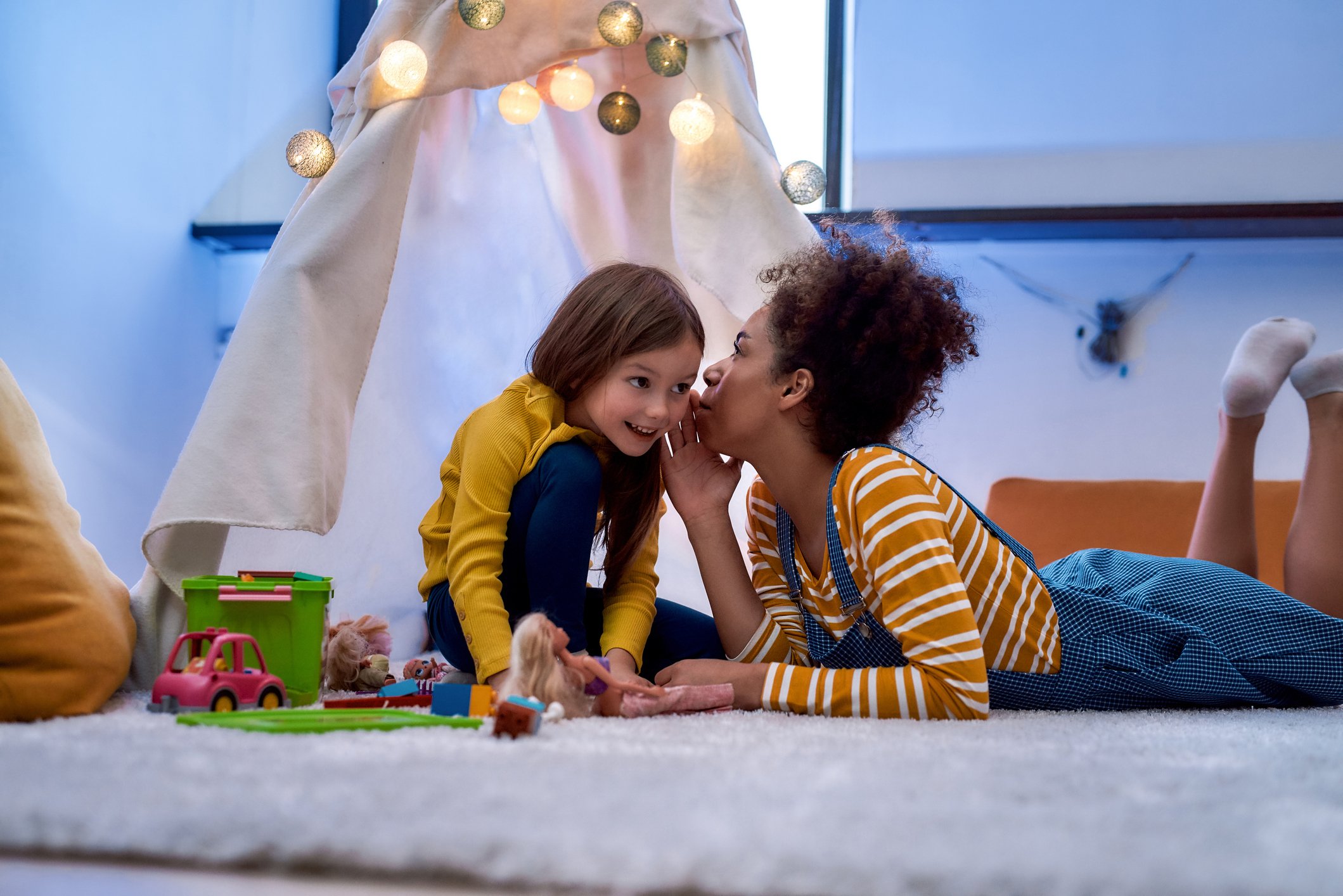 Maida Vale nanny and child having creative Olay with dolls