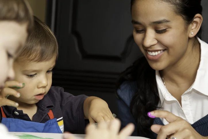 Crouch End nanny with child enjoying art and craft activity.